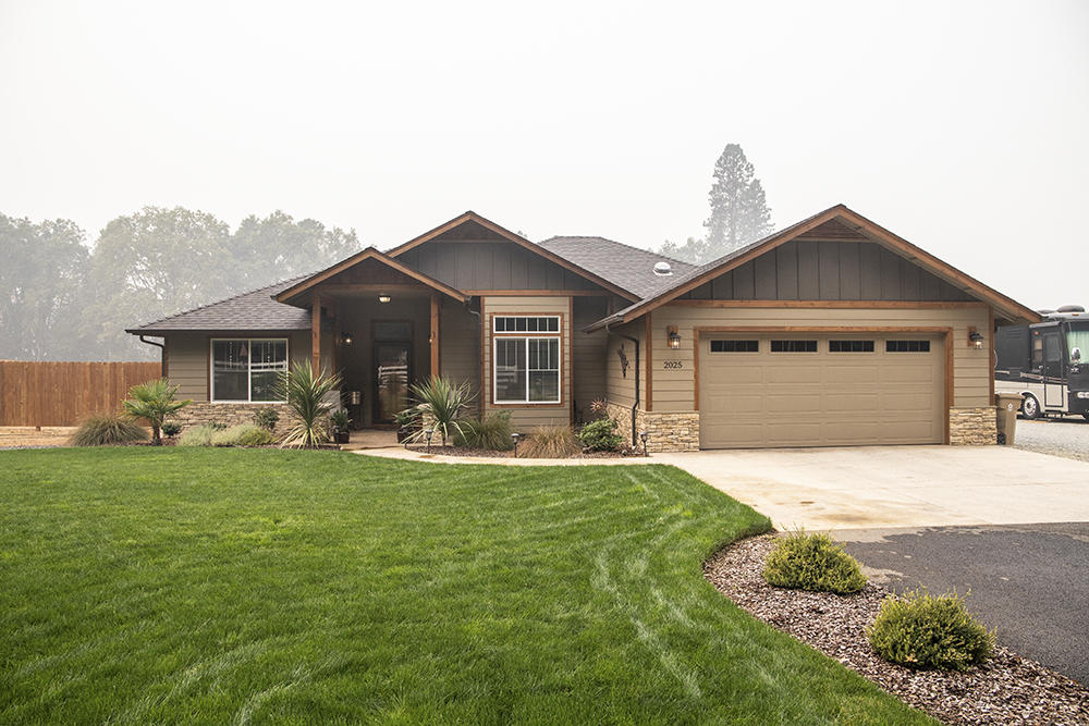 This Gorgeous 2 year old home has a northwest style with plenty of custom details.  It's an awesome property with great curb appeal that features 3 bedrooms, 2 bathrooms, 1857sq.ft., 2 not one but 2 - 24 X 36  shops and RV parking with electrical hook ups. The large covered deck is perfect for BBQs, having fun, or just relaxing and checking out your outdoor TV. Inside you will find an open living room concept with a cozy gas fireplace, an eat in kitchen with stainless appliances, gas range, walk in pantry, granite counters and plenty of storage. The formal dining room with sliding glass doors could also be used as an office or ?.  This property is just outside of Grants Pass and not far from the famous Rogue River. Don't miss out call for your viewing today.