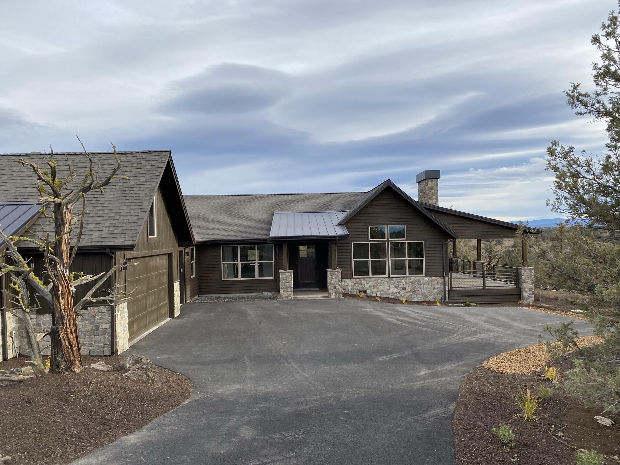One-level new construction home with  Cascade Mountain views and an ideal location on a quiet street yet close to amenities. The exterior features stained wood siding and extensive stone accents. This home has a commanding sense of arrival as you enter the foyer. It is ideal for the entertainer with a large great room, dining room and beautiful kitchen. The kitchen features stainless steel appliances and a walk-in pantry. Slab countertops and island are perfect for the home chef. Beautiful hardwood flooring throughout the majority of the main level, a stone double sided fireplace in the great room that keeps you warm inside and outside on the large deck where you can catch the sunsets while entertaining guests or relaxing with a book. The master suite is an oasis with a walk-in closet, soaking tub and patio access through a vestibule. There is also a den ideal for an office, two additional bedrooms, full sized bathroom and a utility room. An oversized three bay garage finishes the home
