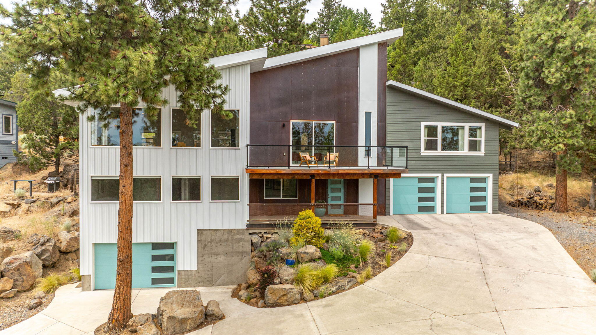 Nestled in the scenic West Hills with abundant natural light, this exquisite property offers the perfect blend of tranquility & modern living. Perched on a ridge with stunning views, this home has been updated & remodeled to feature the latest finishes in an unparalleled setting. The spacious layout includes an oversized great room with ample windows & a deck with views of the city & Mt Bachelor. The modern kitchen includes a large pantry, Wolf range, built-in wine fridge, custom cabinets & quartz counters & a sitting area overlooking the views with a cozy woodstove. The main level primary suite boasts a spacious walk-in closet & a spa-like ensuite bathroom with heated floors. Downstairs are 3 ample-sized guest rooms & a large bonus room. The main level of the home opens up to a level backyard with patio & custom shed.  Conveniently located in an area of top-rated schools, beautiful parks & a short distance to downtown this home offers the best that Bend has to offer!