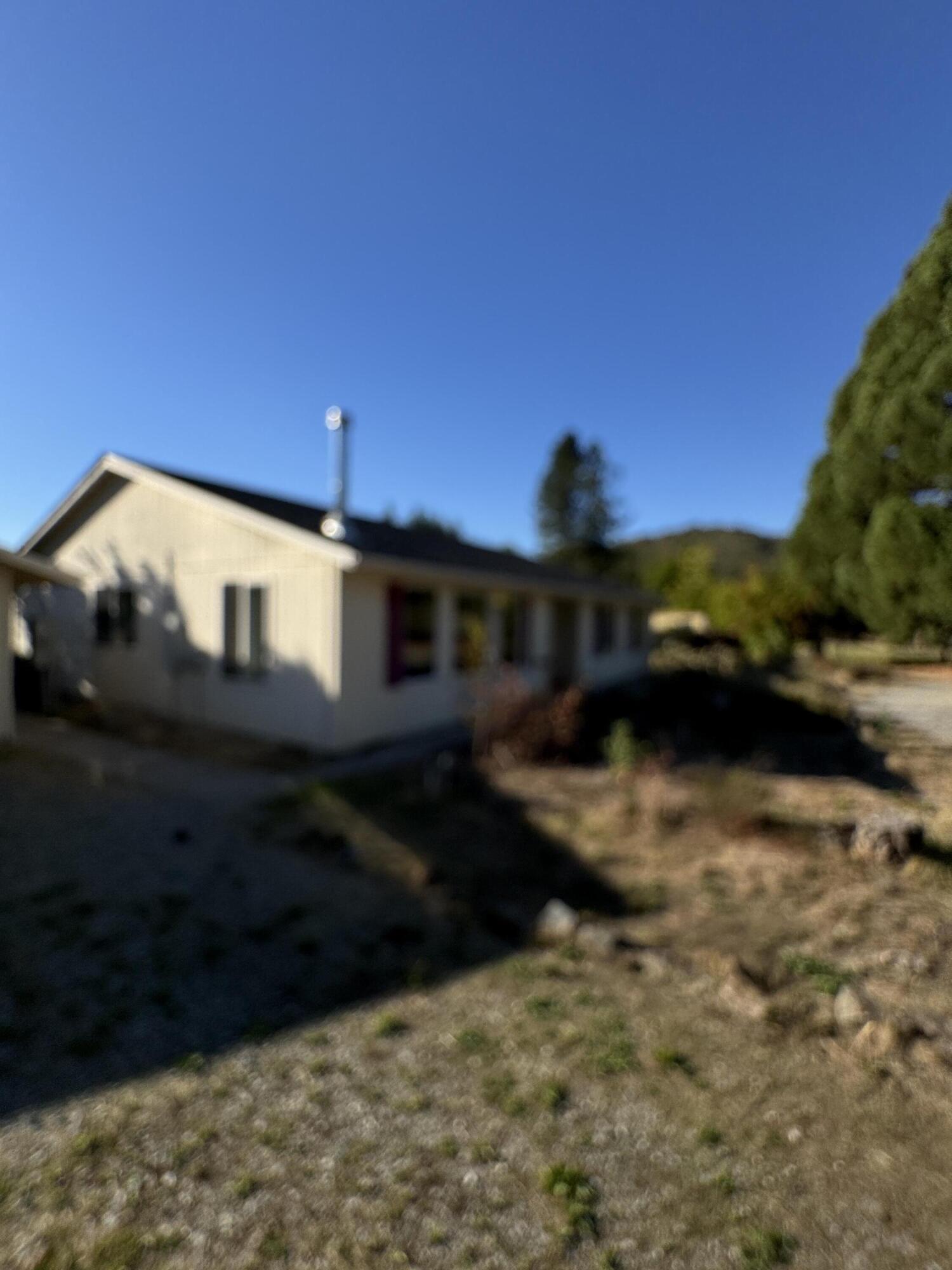 Experience the beauty and privacy of country living! This 2002-built 3-bedroom, 2-bath home offers a serene setting with excellent potential for a horse property. Enjoy wide-open spaces and peaceful surroundings, set back off Old Stage Road for added privacy. Key features include: 16' x 22' garage, 12' x 20' storage building, 30' x 40' barn/shop, a strong well and seasonal creek and direct access to BLM land. Take in the scenic views of surrounding mountains and pastures from your own backyard. Whether you're looking for space to spread out, a hobby farm, or simply a quiet retreat, this property delivers.