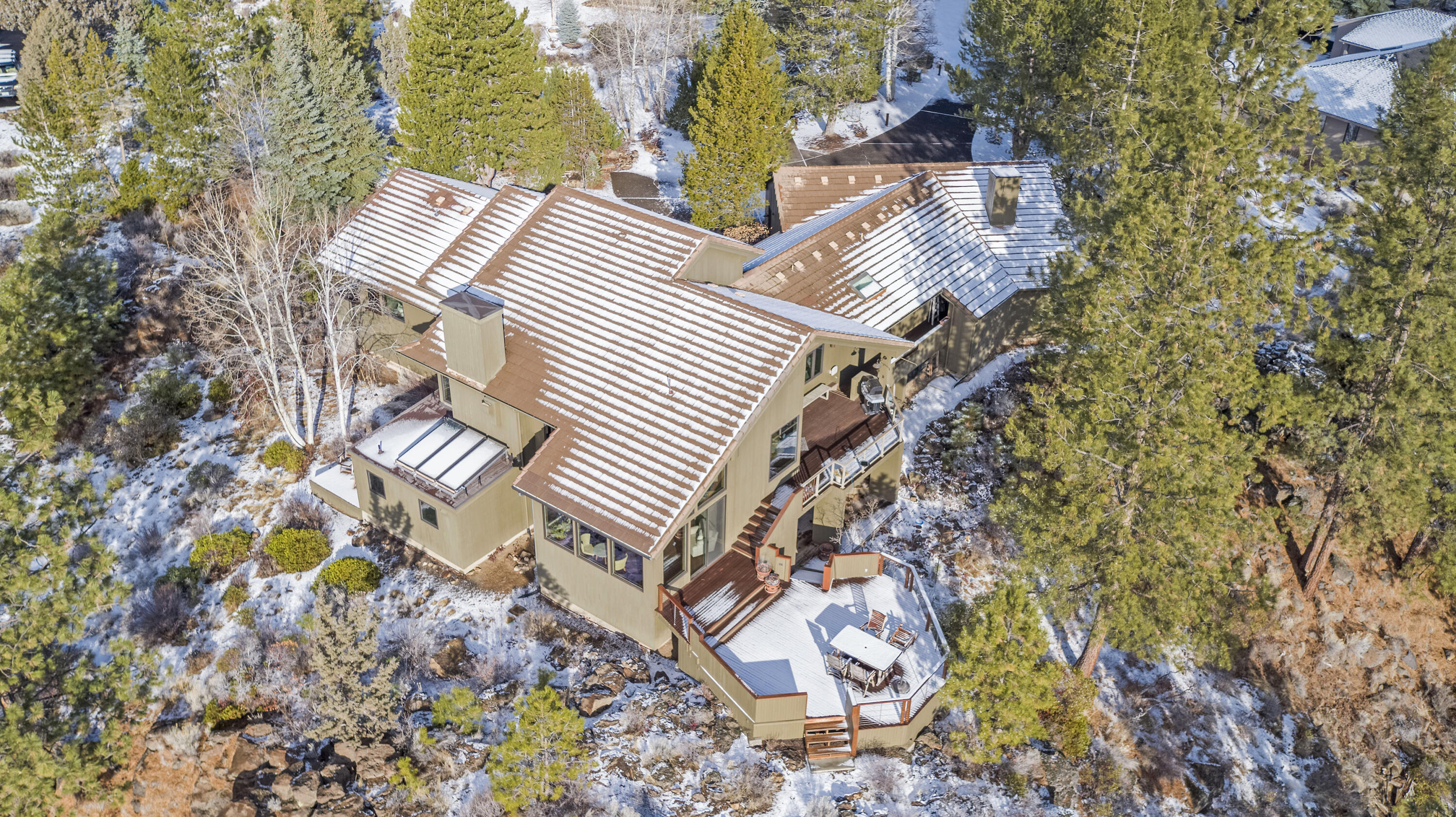 This spectacular custom and updated Mountain Modern home is one of the premier lots in Sunrise Village. The home sits on a .77 ac parcel that juts out over the river rim of the Deschutes, surrounding the home with nature's wonders. 3 ensuite bedrooms, primary on the main with luxurious bathroom and walk-in closet. A 2nd bedroom has a small bonus area, with its own private deck & stubbed for a sink that could be a mother-in-law space. The modern kitchen incl. sub-zero fridge, Wolf range, custom seating bar, and is open to the living room and dining area with its own wet bar. Additional spaces are: large office/flex, sun room, and laundry/project area that could be a 4th bedroom. 4 of 5 baths have radiant floor heat. There is solar-heated water and more storage & amenities than can be listed. Including a heated 3-car garage with utility sink & extra storage room. Sunrise Village is a gated community that includes an updated lodge, pool & spa, tennis courts & potential RV storage.