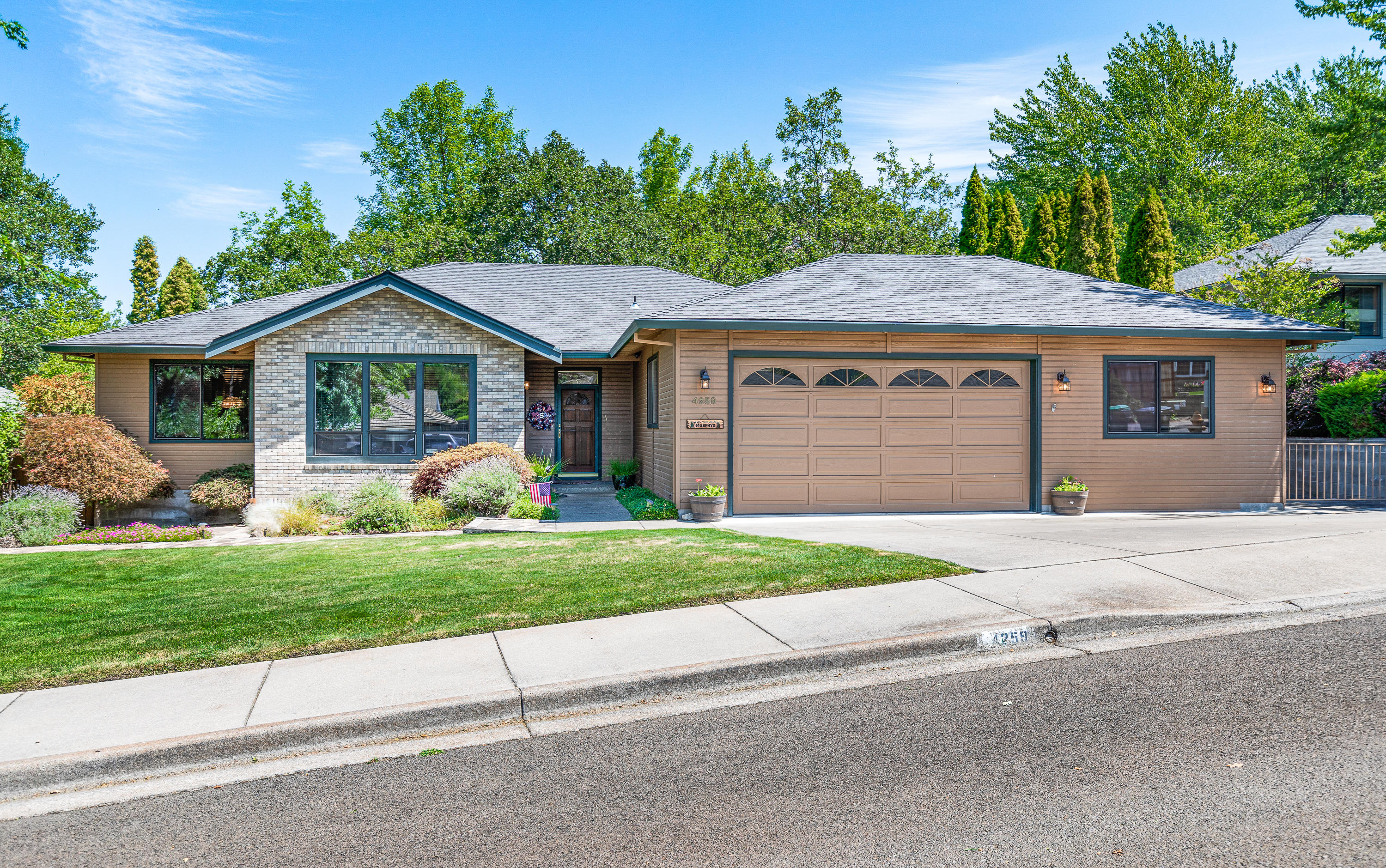 Escape to your own oasis in the foothills of East Medford!
Being in a quiet cul-de-sac in this desirable neighborhood is just the beginning. At the front of the home is a quiet living room with large windows allowing light to pour in. Attached is the formal dining room that leads into the kitchen featuring a garden window and breakfast bar. All this is open to the family room that feels very cozy despite being generously-sized. Down the hall is a fully finished office off the garage and a large primary bedroom with a walk-in closet and on-suite bathroom with dual vanities. Private access from the primary leads to the backyard with three separate sections of decking, a hot tub, and views of Roxy Ann. Down the stairs is an adorable bridge crossing Lazy Creek and a yard that feels more like a campground than a neighborhood. All this backs up to nearly 15 acres of undeveloped land, giving you privacy from everything except for the birds and occasional family of deer.