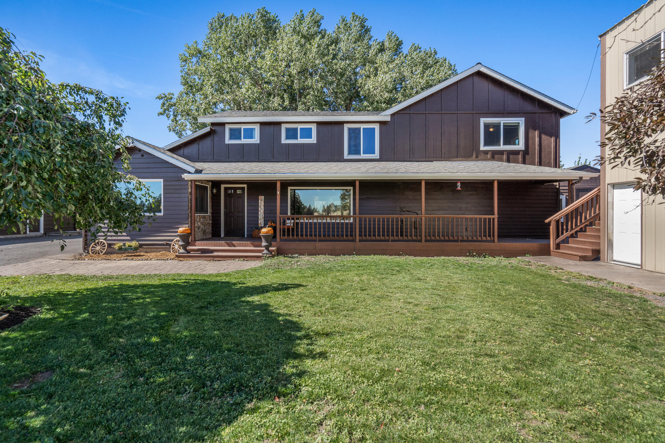 Come see this perfect small acreage with endless possibilities in Bend, Central Oregon's dream mountain town! Lovingly curated over the last 14 years, the owners have continuously improved the 9.98 acre property, its fenced pastures, outbuildings & barn. The original home is remodeled and transformed into a larger 4 B/3ba traditional with a media/bonus room, knotty alder doors and trim & hand scraped birch floors in the primary suite. A newer detached structure with hardwood floors & tongue and groove pine ceilings makes the perfect office. A 2-story metal shop building is ideally situated adjacent to the house & does double duty as shop garage for all your toys below & the upper level work space with multiple rooms has great flow, perfect for welcoming clients to your ''work from home'' based business! The barn with four paddocks, a large irrigated pasture, four smaller pastures, hay storage garage & animal shelter for goats/dogs rounds out the property. 4 acres irrigation