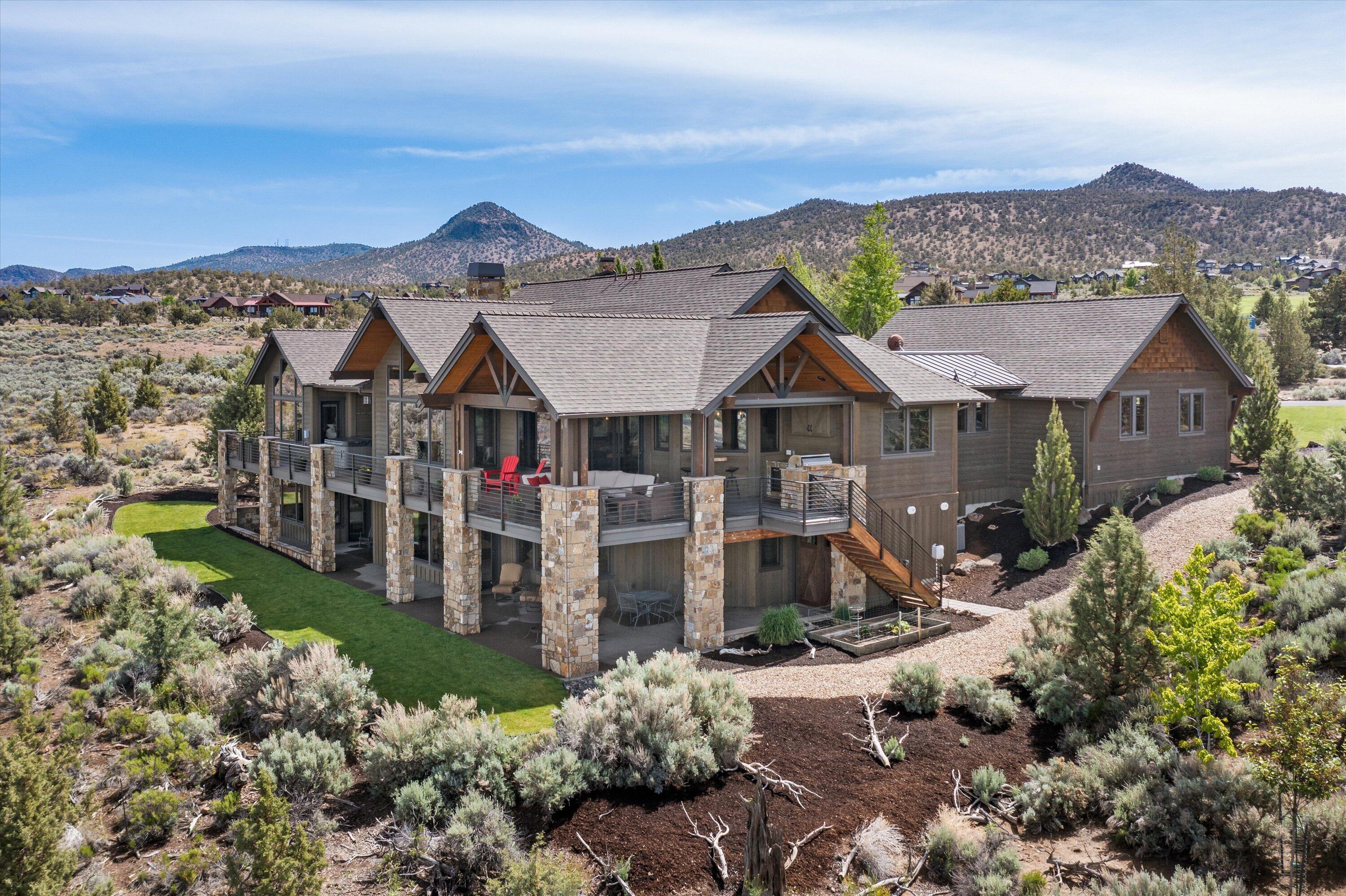 This stunning 4500 Sq Ft, 4 Bed, 3.5 BA Northwest style home is perfectly situated to provide unforgettable views of the 15th green and Hole 16 at Brasada Canyons while offering unfettered panoramic views of the Cascade Mountains to create the perfect bespoke Brasada backdrop. 
Unmistakable craftsmanship and quality of materials abound as you enter into the open, vaulted great room and warm kitchen/dining area. Step outside and you will find a deck that spans the length of the entire home. The deck area features a large covered portion with a gas firepit and outdoor kitchen. Coupled with the aforementioned views, this outdoor living experience is virtually unparalleled. 
The primary bedroom offers vaulted ceilings and a cozy fireplace with direct access to the deck hot tub. Adjourn downstairs and you will find a media/game room complete with a fully outfitted bar and a walk in wine room, perfect for tastings. Two additional bedrooms and a bunkroom complete this wonderful home.