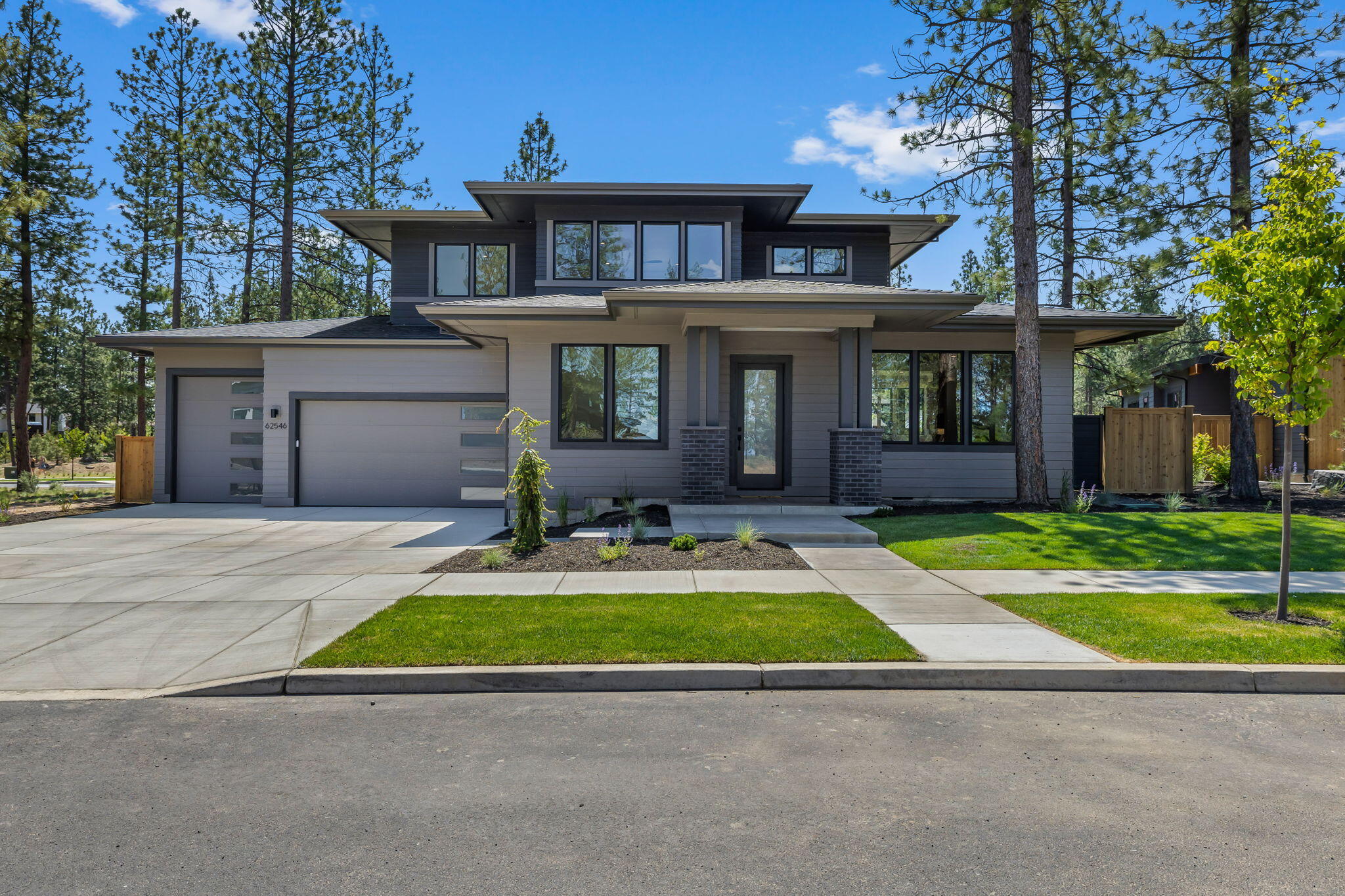 Stunning contemporary prairie-style home by Bruce Wiechert Custom Homes, Inc., in the highly desirable Shevlin West community. This thoughtfully designed residence blends modern elegance with timeless craftsmanship, featuring exquisite rift oak cabinetry, custom lighting, hardwood flooring, and high-end Thermador appliances. A wide, flat driveway welcomes you home with curb appeal and convenience. Back-lit bathroom mirrors add a touch of luxury and function. Built with care and attention to detail, the home offers a spacious main-level primary suite, dedicated office, and open-concept living that flows to a flat, fenced, private backyard—perfect for entertaining or relaxing. Upstairs, a generous loft and two ensuite bedrooms are ideal for guests or multigenerational living, with Cascade Mountain views from many rooms. Enjoy direct access to miles of trails and the new Manzanita Ridge community park. A rare opportunity to live in style, surrounded by nature.