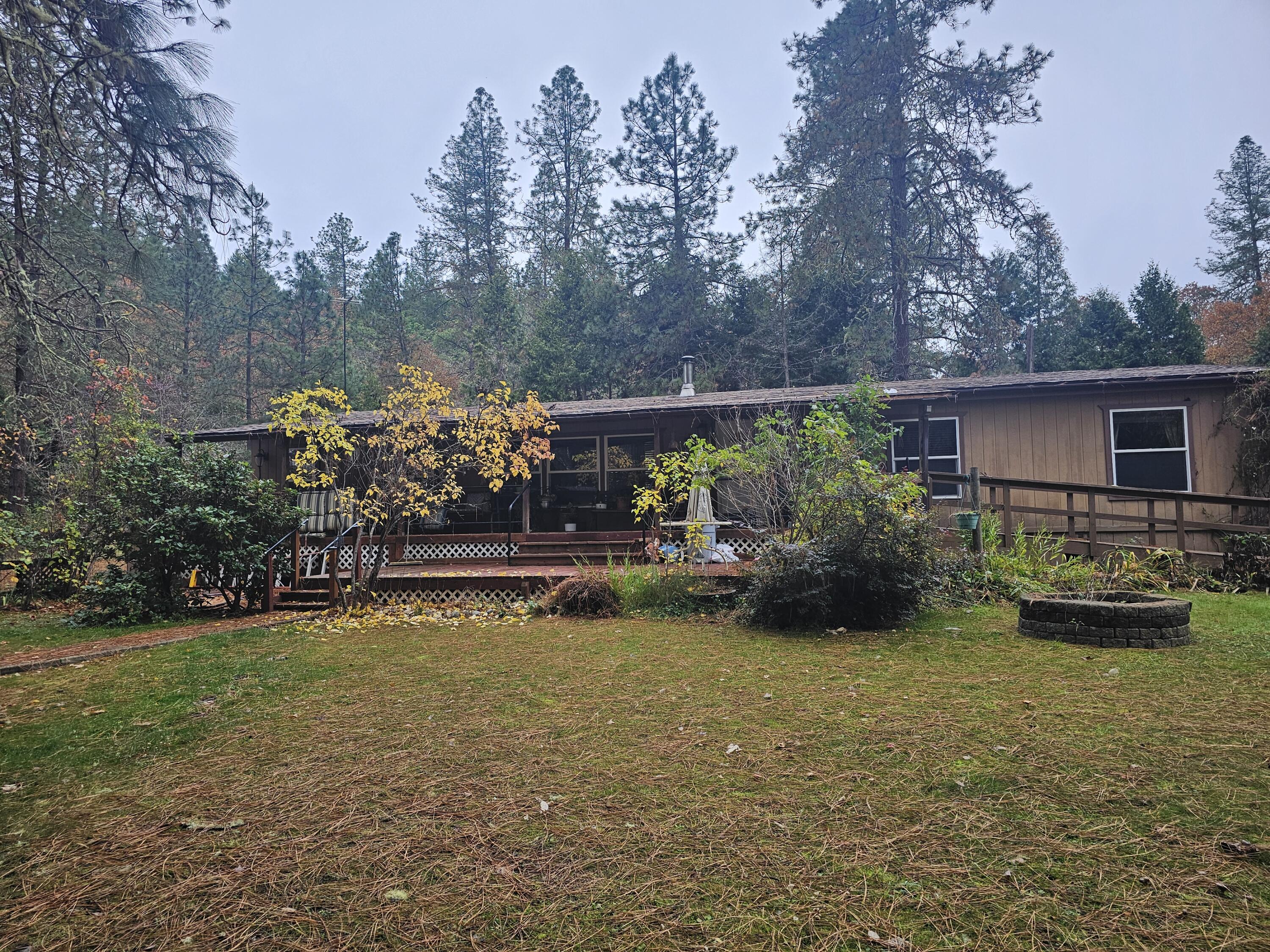 Welcome home to this peaceful retreat! This 4-bedroom, 2- bath gem offers an ideal blend of space, comfort, and nature. Relax in the bright sunroom or on the wrap-around deck surrounded by mature trees, vibrant flowers, and a tranquil Koi pond. The split bedroom layout provides privacy, while the office and large rec/sunroom offer flexible living space. Exterior features include sidewalks around most of the home. Enjoy the convenience of a detached garage, dual carports, two sheds, fenced garden, and level, gated property - perfect for gardening, pets, or outdoor entertaining. For the outdoor enthusiast and fisherman Robertson Bridge Boat Landing is just a stone's throw away. A wonderful blend of comfort, charm, and natural beauty!