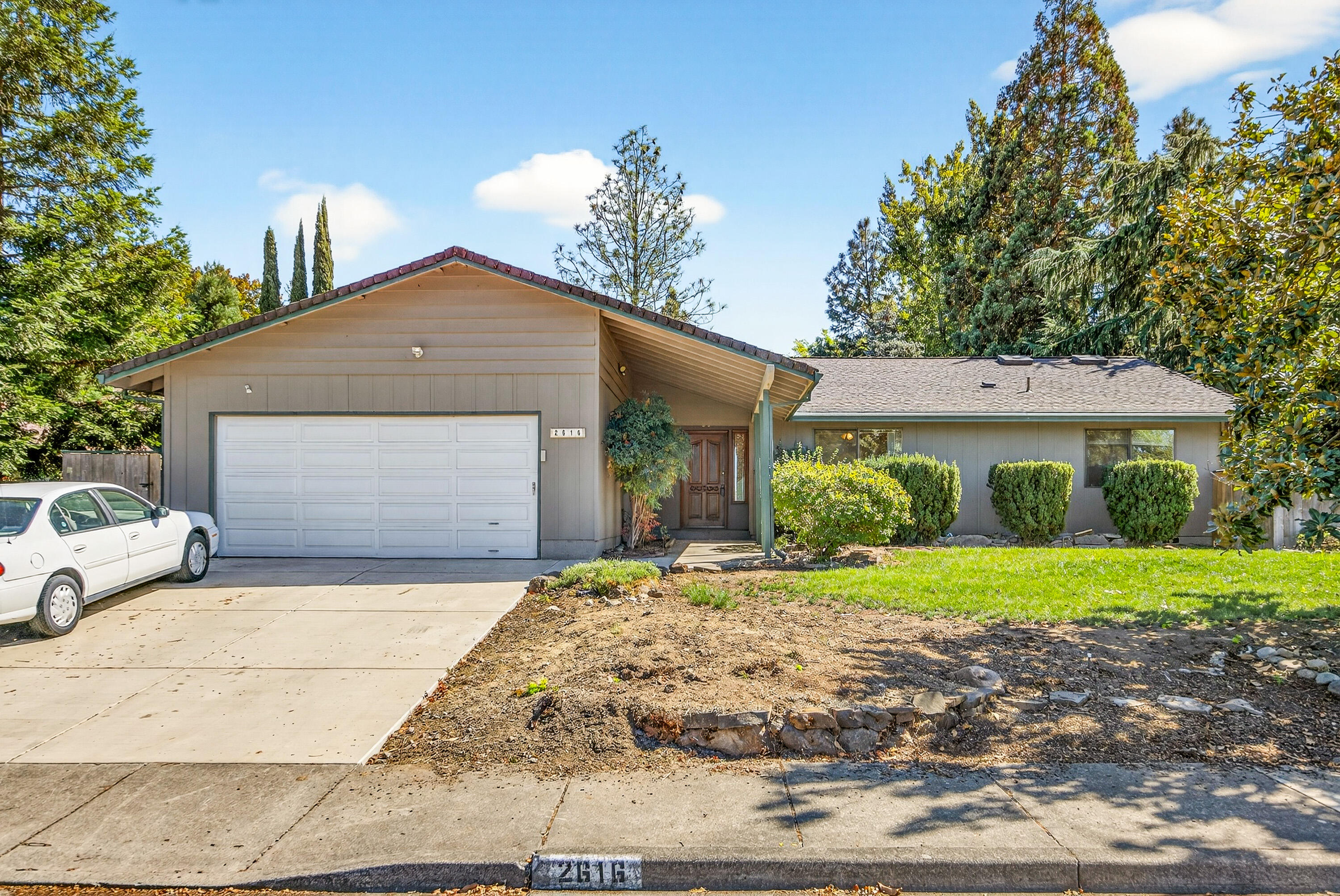 Welcome to this charming single-story home, nestled in the highly desirable East Medford neighborhood with stunning mountain views. This 3-bedroom, 2-bathroom gem offers a spacious layout perfect for family living, featuring a cozy living room, separate family room, and a wood-burning fireplace for those cool evenings. Step inside to vaulted ceilings and abundant natural lighting that create an airy, inviting atmosphere. The well-appointed laundry room provides ample storage, while the updated features include a brand-new driveway installed in 2025. Outside, entertain in style with a large yard ideal for gatherings and an inground pool equipped with a new pump. Conveniently located near shopping, restaurants, and schools, this property combines comfort, convenience, and timeless appeal—don't miss out!