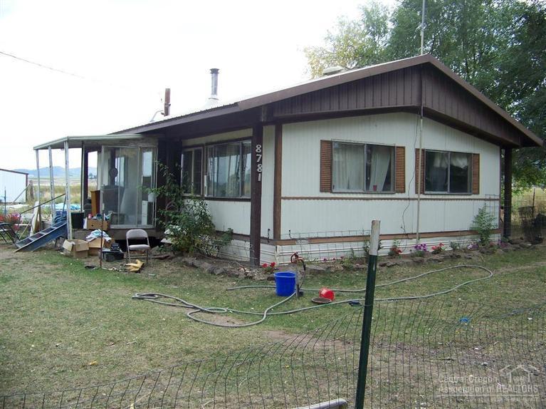 Nice sized irrigated parcel. Home could use some TLC but has lots of potential. Outbuildings include detached garage/shop and metal lean to. Easy access