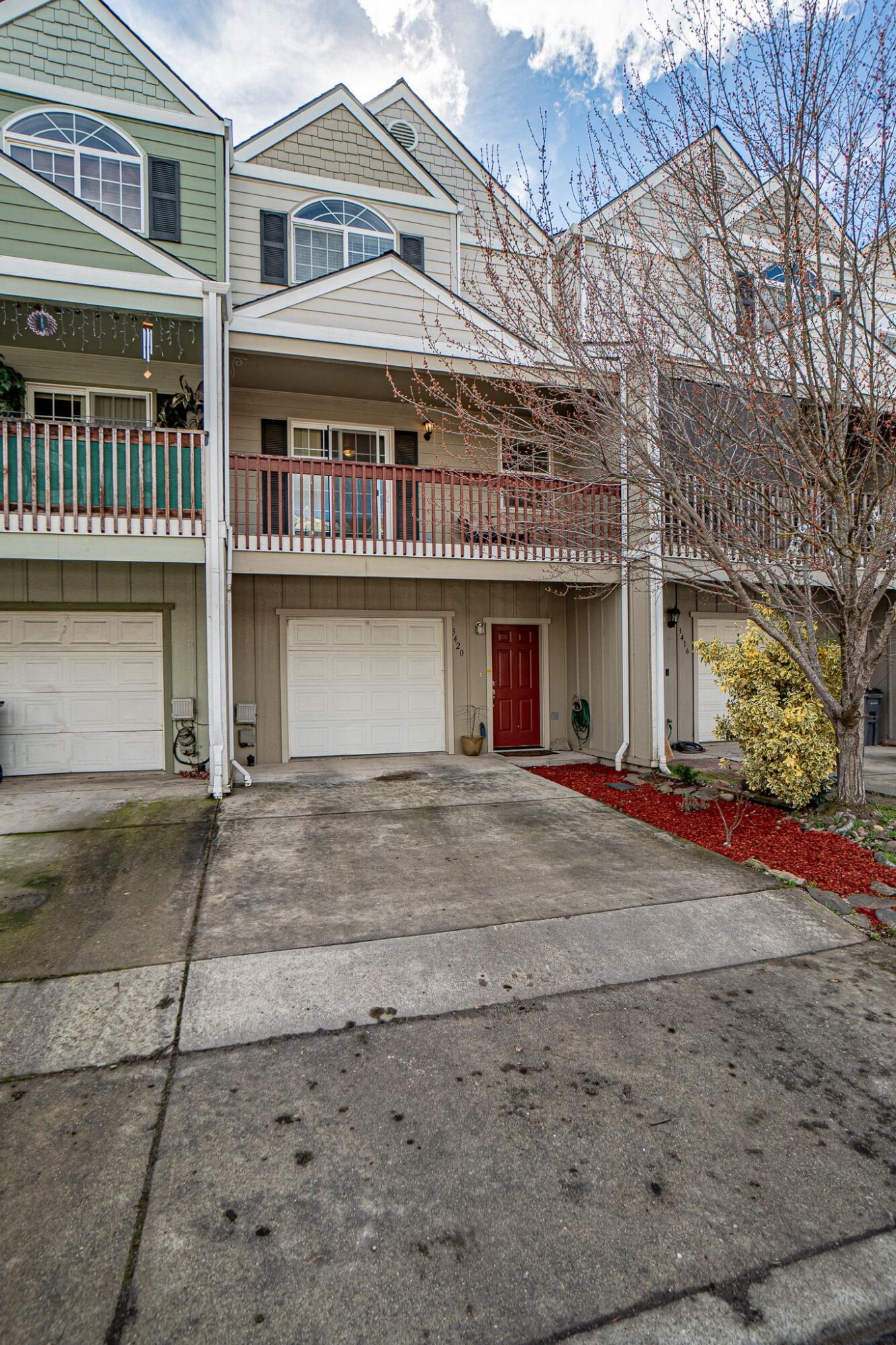 Back on Market at no fault of property! Absolute pride in ownership that really shows in the 3-bedroom 1.5 bath tri level townhome with single garage. You will be amazed to find that the middle floor living has balcony decks both front and back of the spacious home. Open concept brings inviting time with loved ones, and low maintenance for the convenience's. The living dining and kitchen area's are open and roomy bringing natural lighting, ample storage closets, cabinets and good amount of countertops in the kitchen. The eating bar is great! There is a cozy ½ bath on the main mid-level, and the 2 upper unit bedrooms share a full-size bath, both hosting nice size closets and windows to take in the mountainous southern Oregon views. The main floor has a 3rd bedroom that can also be a hobby/ home gym or storage if preferred and a small courtyard for pets/garden etc. This is a home you won't want to miss! (No HOA's!)