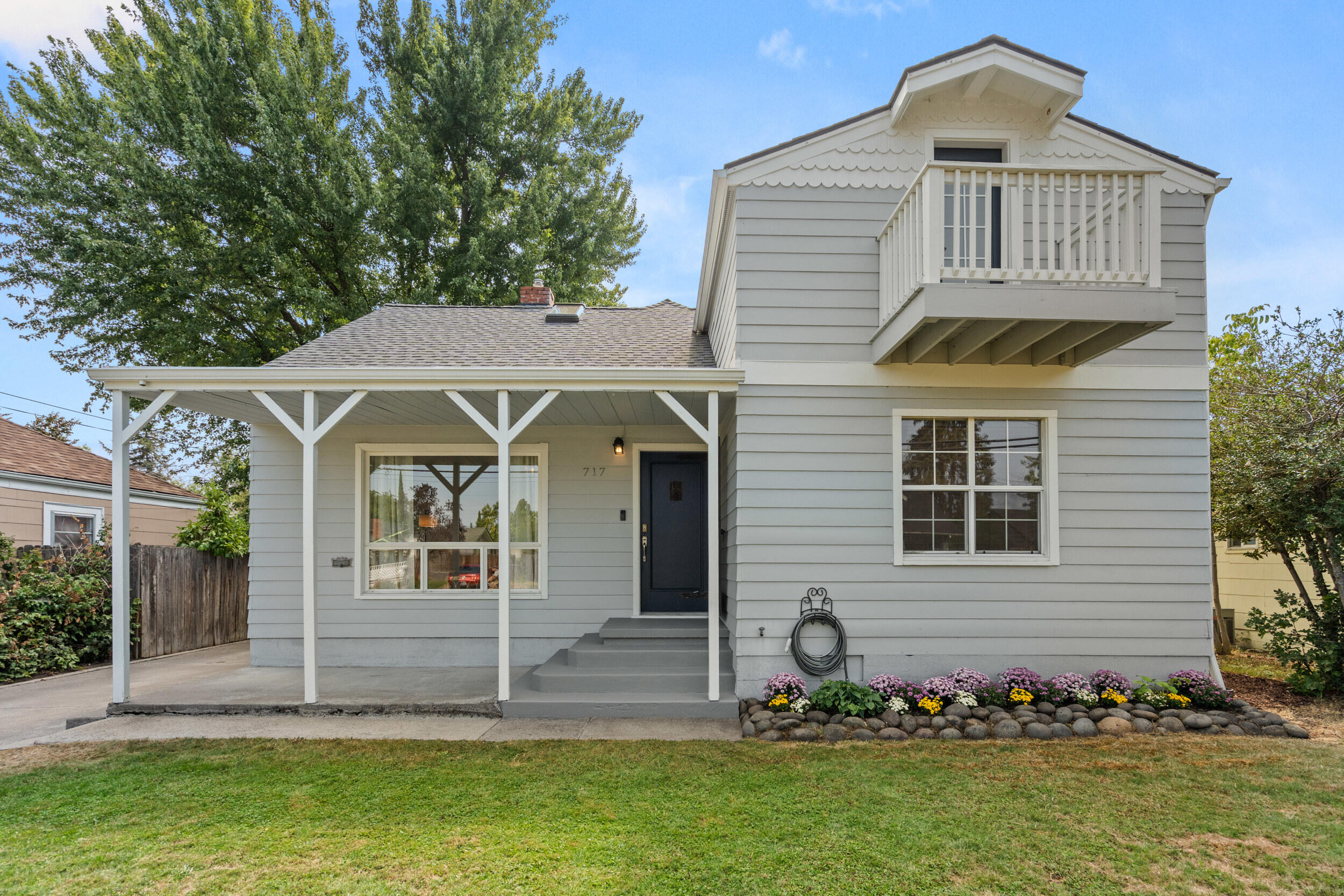 Character and charm await you in this move-in ready, 3 bed, 2 bath home with light-filled living spaces, classic original details, and unique built-ins offering ample storage. The main floor features a retro-style kitchen, a separate laundry room, and open concept living and dining spaces with french doors leading to the back deck. On the newly-carpeted upper level, possibilities abound! The large space can be a fourth bedroom, office, or family/playroom. Or use the entire floor for a large primary suite with a full bath, walk-in closet, and balcony. Outside, there's plenty of room to relax or entertain on the covered deck, and the nicely sized backyard offers lots of options for outdoor living, gardening and play. An extra-long driveway provides parking for multiple cars (possibly RV) and leads into a garage/workshop with alley access. Other amenities include a basement, individual A/C systems for top & bottom floors, and a 50-yr roof (2021). Come see this fantastic home!
