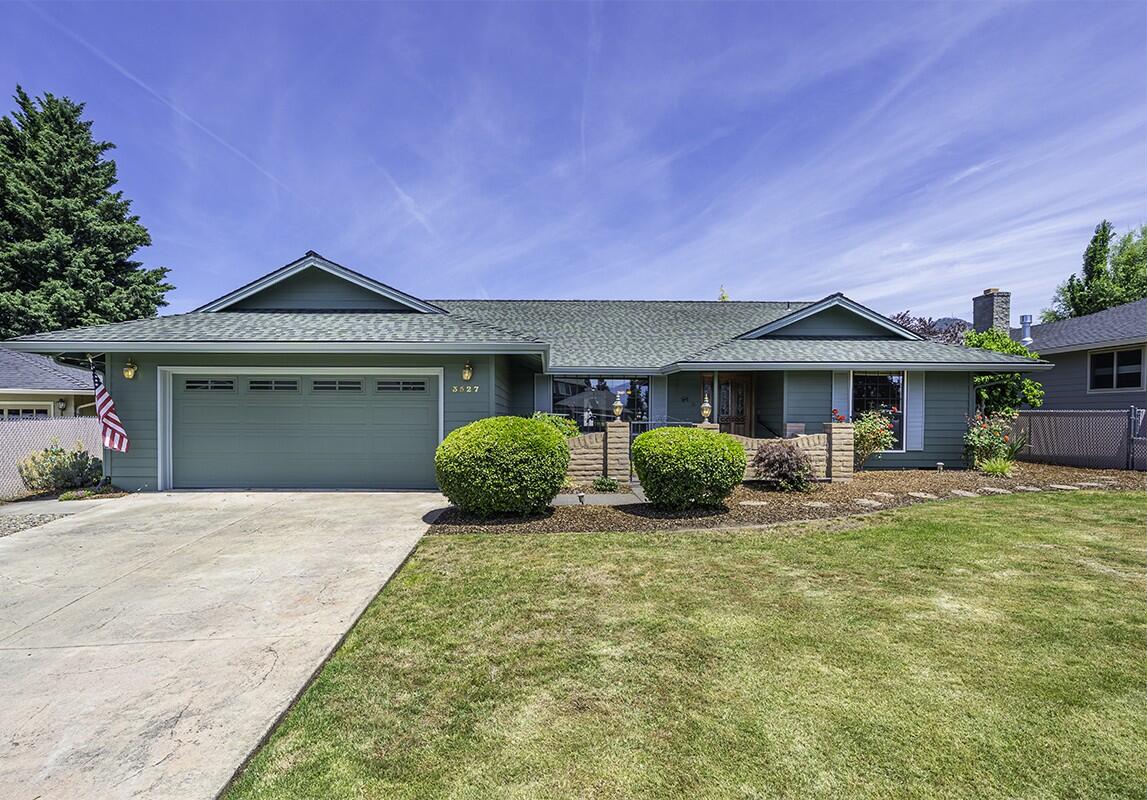Charming, single level 3 bed, 2.5 bath home perfectly placed within minutes of schools, shopping, golf and Rogue Regional Medical Center! Updates and features throughout including hardwood floors in the main living areas, multiple spaces for living and dining and a dedicated laundry/mud room with built-in cabinetry. Convenient kitchen equipped with ss appliances, breakfast bar, granite countertops, unique pass-through feature & tile floor. The cozy family room features a gas insert fireplace framed by brick surround and classic wood mantle. It connects directly with the kitchen and back patio, perfect for entertaining. Spacious primary suite with private patio access and ensuite boasting tile floors, a dual-sink vanity & linen closet. The fully fenced yard includes mature, low maintenance landscaping, raised garden beds, storage shed & side yard. 2-car garage with built-in storage & EV hookup. Don't miss this fantastic property!