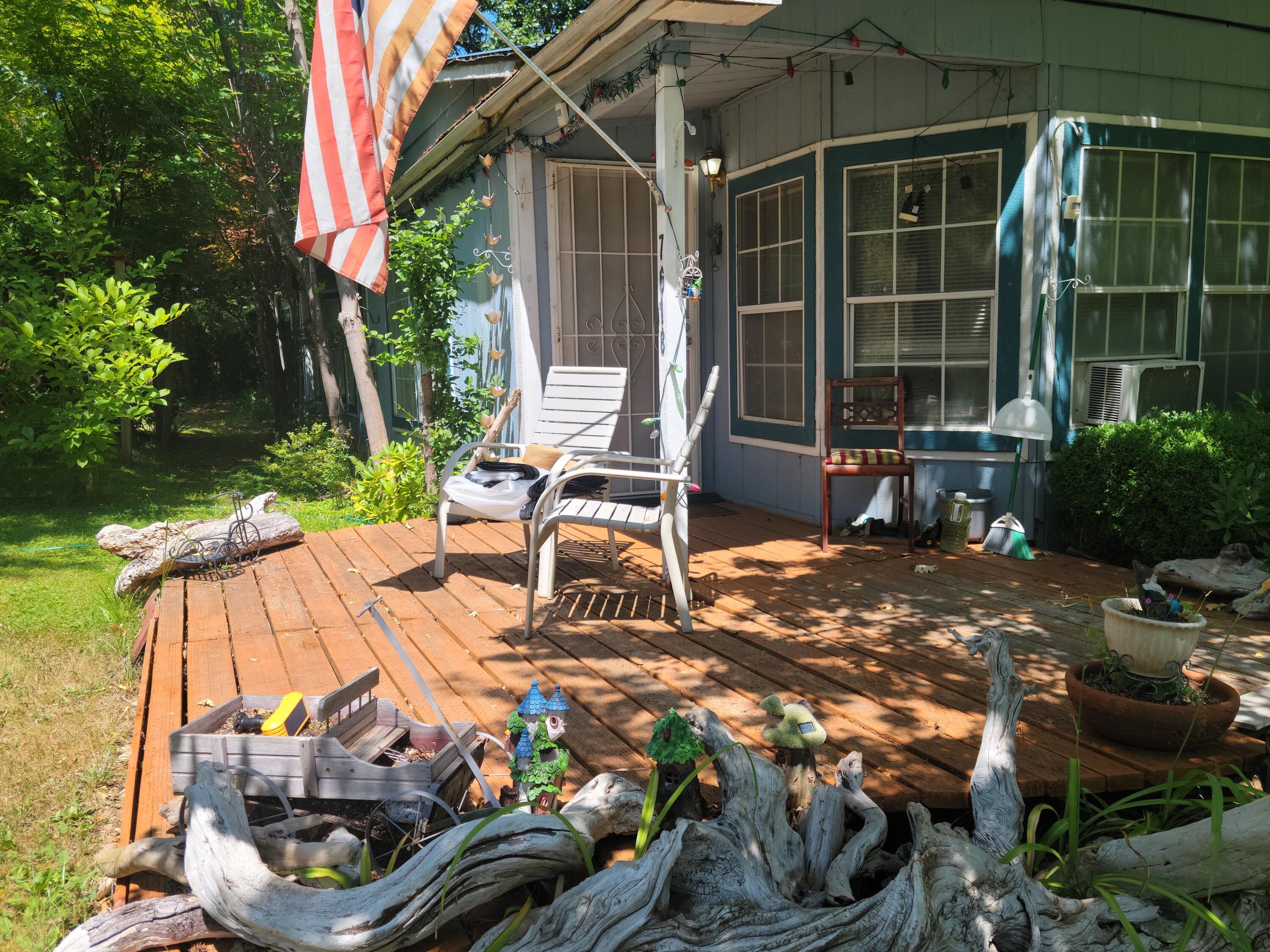 Here's your opportunity to own an incredible 2.63 acres of secluded land in an area untouched by city or traffic noise! Sitting on this property is a  2,076 sf double-wide manufactured home built in1990. The bedrooms are good sized. The primary bedroom has a large walk in closet, an en suite bathroom with a garden tub & shower. The guest bathroom has a double vanity & tub/shower combo. Several years ago it housed horses and had arenas and work out areas. Now, the main out-buildings are a walk-in chicken coop, storage barn, green houses and storage sheds. For cars, there is an extra tall car port that can accommodate tall RVs or several autos. Like fruit trees? There are 3 plum trees, 4 fig trees, 2 peach trees, apple trees and 3 pear trees. In the fenced garden area: Marionberries, Loganberries, & raspberries; and strawberries, zucchini and spaghetti squash, tomatoes, garlic, kale, parsley... Too much to list. (See list of repairs.)