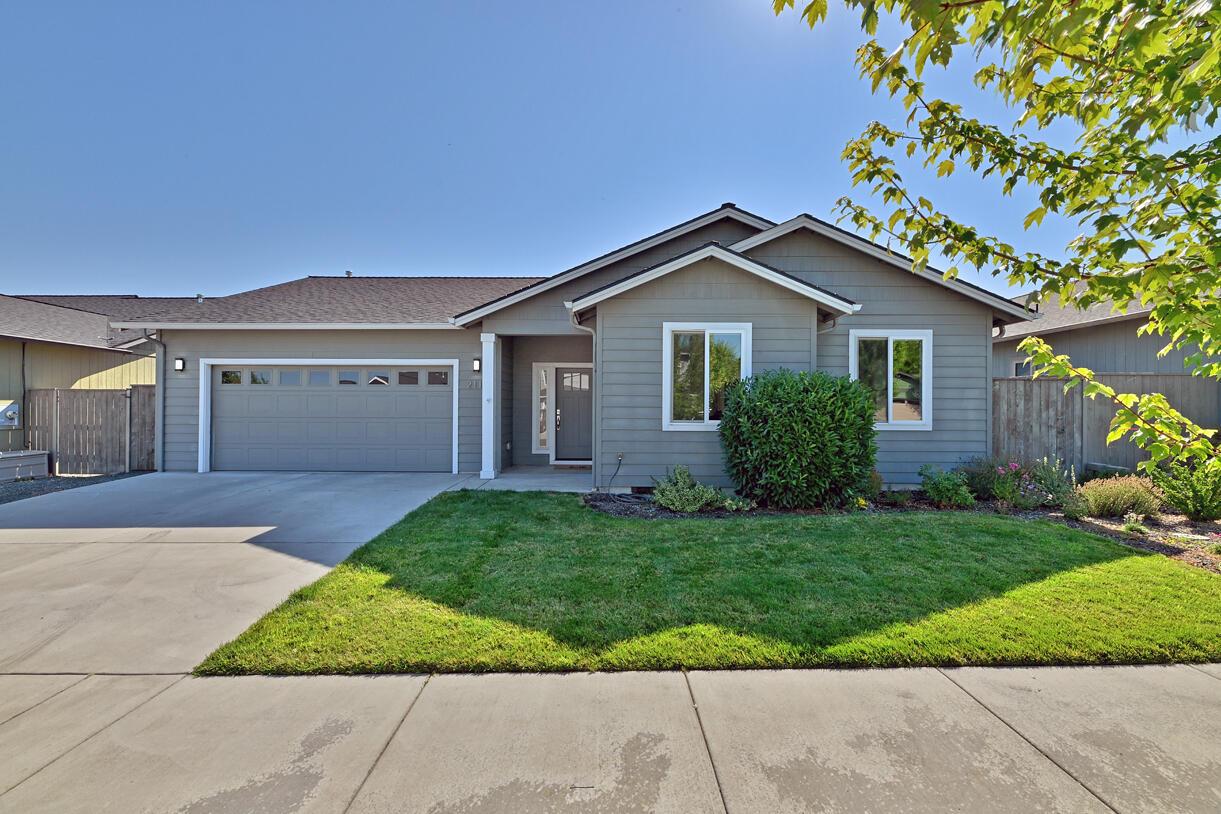 Discover this beautiful 2019 built home on a quiet street in Southwest Medford. Boasting an open floor plan and luxury vinyl plank flooring throughout, this home is ready for you to move in and make it your own. The stunning kitchen features granite counters, a kitchen island, and stainless steel appliances, perfect for culinary enthusiasts or entertaining. Vaulted ceilings and a gas fireplace with stone surround create a warm and inviting atmosphere. The primary bedroom is a serene retreat, complete with a spacious walk-in closet and the bathroom features a custom tile shower. Professionally maintained landscaping adds to the property's curb appeal. This is modern and comfortable living space, perfect for those seeking a stylish and functional home.