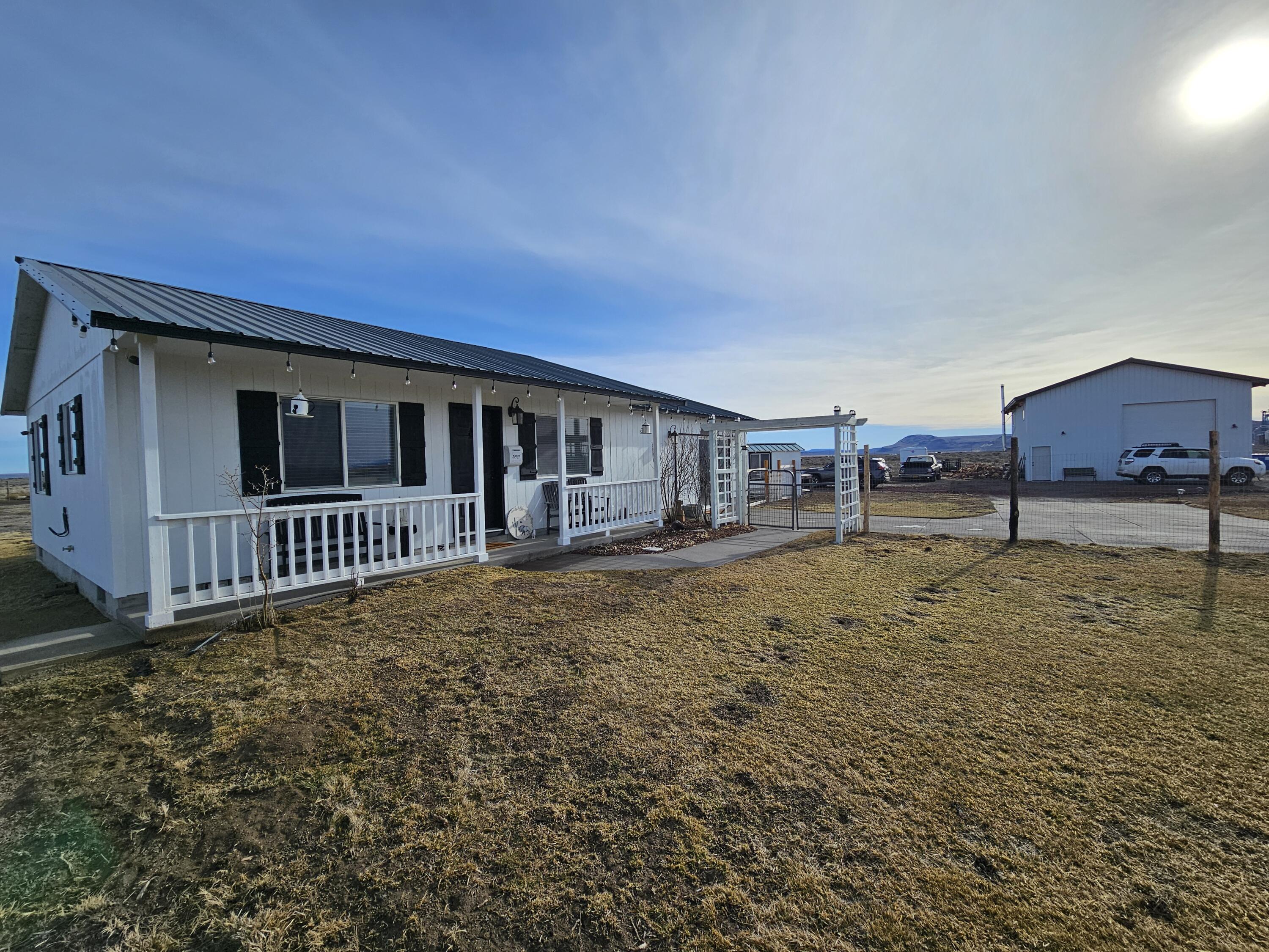 Beautifully updated home with much to offer! Almost 20 acres of flat land to make your own. Many upgrades have been made, including new floors and interior/exterior paint. Newer shop provides tons of storage with lots of room to work out of. Gorgeous Gazebo for hosting events. Greenhouse and fenced in garden ready to go. Chicken coop in the back. Garage has been converted to living space giving extra room. This property has much to offer, call today to schedule a tour!