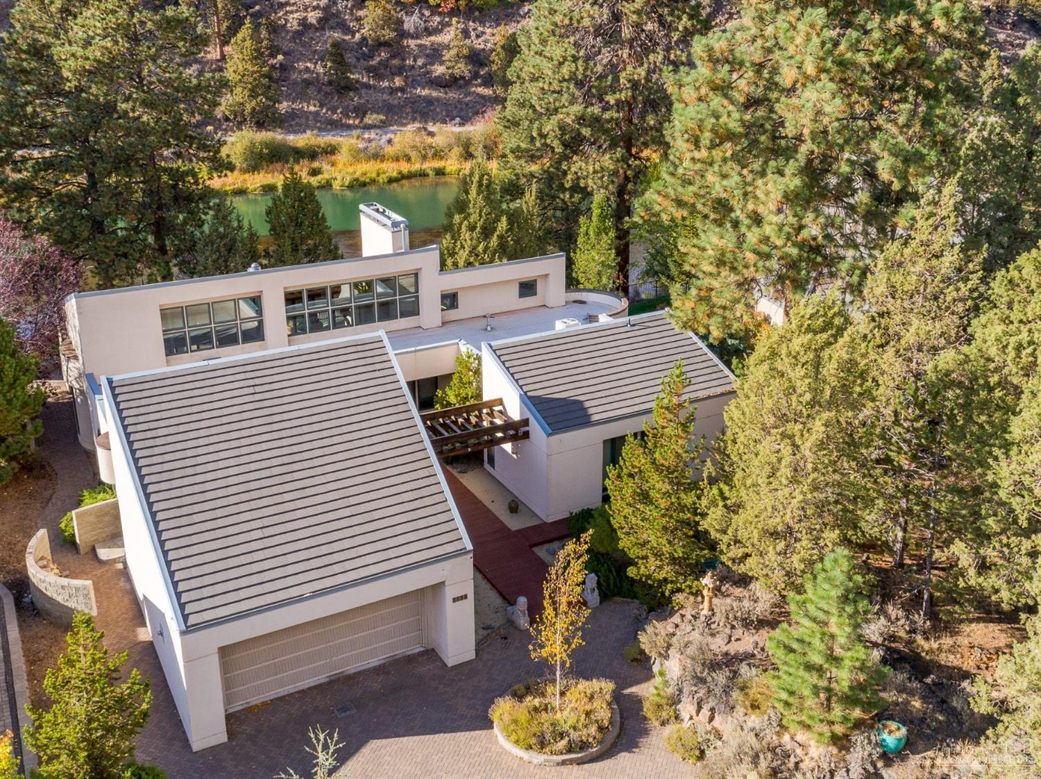 Unmatched waterfront setting on the Deschutes River in the heart of Bend close to down town. Beautiful comtemporary arcitechure on a large .83 acre lot makes for an upmatched setting. Large teak deck and paver patio overlooking the river. One story living with chef's kitchen and large open great room. Master bedroom has views of the river with a beautiful master bathroom including jetted tub and large tiled walk-in shower. All three bedrooms have private outdoor patios. Built in Vac system with ample storage throughout the home. Less than a mile from down town.