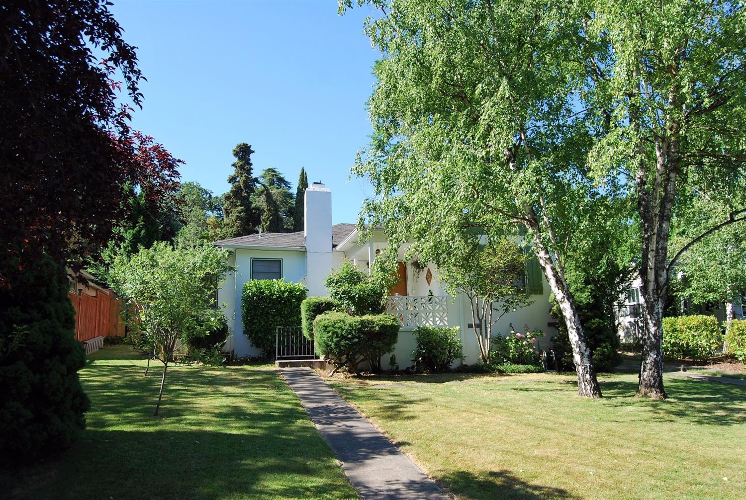 Charming Old East Medford cottage in a sweet location close to Hedrick and Roosevelt! Great curb appeal in this Spanish style home on larger lot with trees including fig, apple and pear. Living room with hardwood floors and fireplace. Dining area with hardwood floor, lots of windows. Kitchen with door to rear yard and included refrigerator. Master bedroom with ceiling fan and 2 closets. 2 guest bedrooms, one with access to kitchen area would make a great home office. Bath with charming tile, newer fan/light, and tub shower with cultured surround. backyard is private with trees and mature landscaping and inground sprinklers. Detached garage off rear alley is great for projects, storage, hobbies and has dryer hookup. Washer/dryer included in sale. New heat and air in 2010. Beautiful refinished hardwood floors, arched doorways, and tons of character in this home!