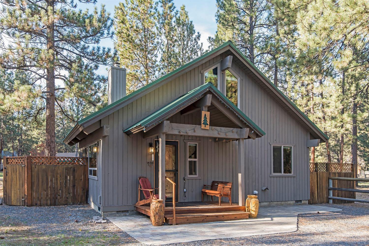 Charming Cabin on half-acre lot with inviting open floor plan, high beamed pine ceilings, a cozy wood stove, and a bedroom and bath on both floors. There's lots of outdoor entertaining areas; new decks, paver patios, fire pit, and outdoor shower. The home has been recently renovated with NEW appliances, kitchen counters, sink, new heat pump, duct work, carpet, showers, windows, and blinds. Fresh paint inside and out. Included are a complete set of engineered plans for a double garage with a second floor!