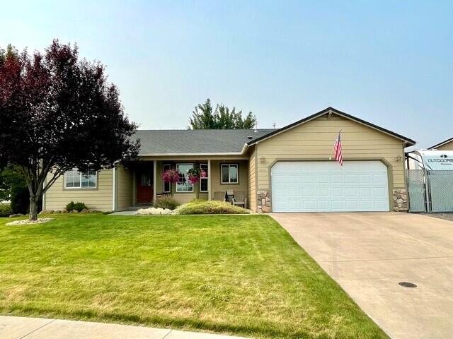 Pride of ownership shines through and through! This home is located in a nice neighborhood and move in ready! Featuring a great open floor plan with vaulted ceilings in the living room and gas fireplace. The primary suit is separate from the other 2 bedrooms featuring a nice walk-in closet, double sink vanity in the on suit bath with oversized step in shower. Updated wood grain tile flooring throughout with carpet in the bedrooms. Gas forced air heat with AC. Out the back is a great yard for entertaining, BBQs, or simply relaxing. Landscaped, fenced yard, with covered patio, sprinklers front and back, oversized shed for storage or yard equipment, and gated RV parking with additional graveled parking off the street. Concrete drive leads to a tidy 2 car garage. You will not want to miss this home!