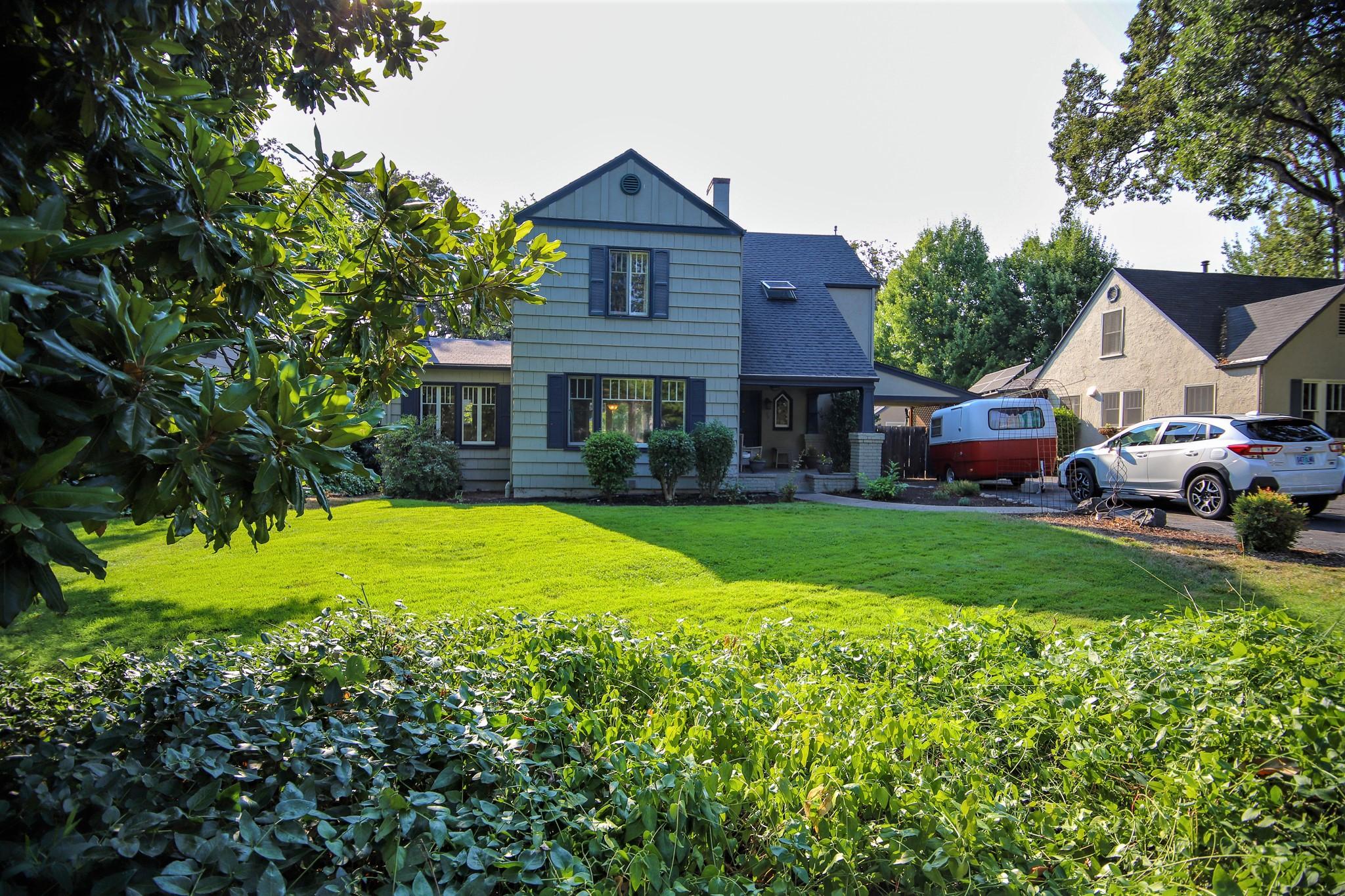 Located in one of Old East Medford's finest neighborhoods! This quaint 1930's home has maintained its charm & unique appeal. The large main level living room boasts a wood burning fireplace, large leaded windows that fill the room with natural light, real wood flooring, arched doorways & charming built-in bookshelves. The cozy kitchen is light & bright with white cabinets, black accents & breakfast nook.  The formal dining room with French doors leads to the wonderful back patio & fully fenced yard featuring an inground pool, perfect for those hot summer days, a lush green lawn & large mature shade trees. The downstairs master is currently being used as a family room. Upstairs you will find the additional 3 bedrooms that are all large & have a wonderful feeling of yesteryear.  You will love the curved door, that leads to a nice office space with skylight. This home sits back from the street & if you like the charm of vintage homes, this one will steal your heart!