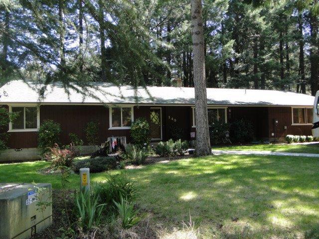 Located at end of cul-de-sac and surrounded by stately trees, this spacious and comfortable home offers 3 bedrooms, 2 bathrooms, walk-in pantry, 14'x16' insulated workshop with shelving, and RV parking. Sliding glass door in master bedroom provides access to the backyard and large deck. Attached 2 car garage.