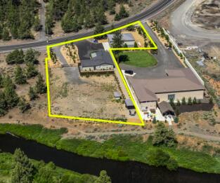 Motivated seller with a huge price reduction! Incredible opportunity to own a .17 acre RIVER FRONT BUILDABLE LOT w/ a fully furnished, remodeled ranch home! This property sits on half an acre along the Deschutes River, near Tumalo State Park, and comes with .3 acres irrigation water rights. The open floor plan features a stylish kitchen with custom cabinets, solid surface counters, tile backsplash, and stainless steel appliances. The primary suite offers a spacious closet and a luxurious ensuite with double vanity and tiled walk-in shower. Outdoor living is a dream with a covered patio and riverside fire pit. The property also boasts a paved driveway, attached double car garage with epoxy floors, and a massive 1,728 sq ft detached shop complete with two 12x14' garage doors, 2 RV dumps, 440 amps of power, full insulation, sheetrock, and a bathroom with shower. Operating as a short-term rental.