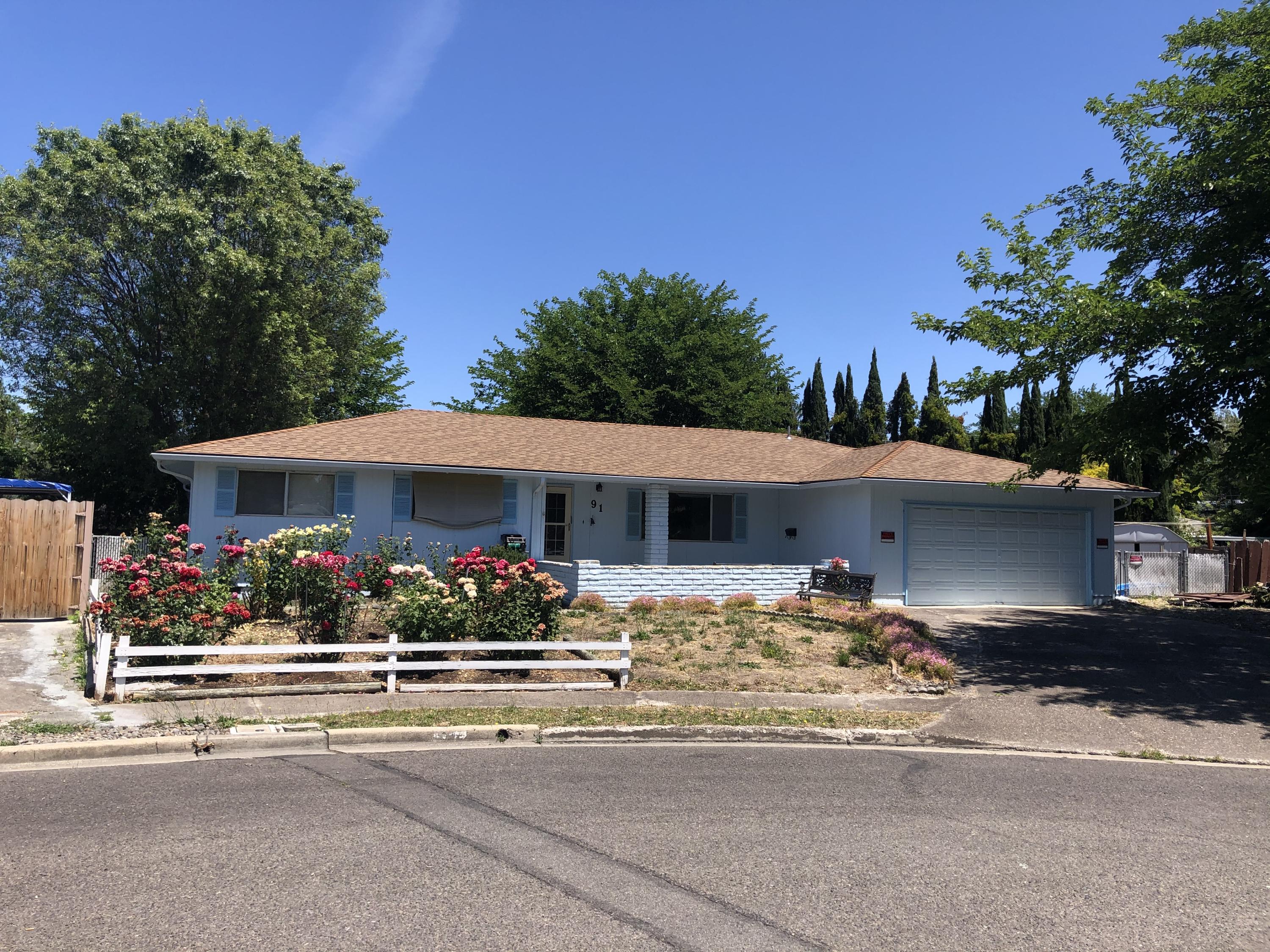So much potential in this 3Bdr/2bath home in a quiet neighborhood.     Situated on a large .24 lot with mature trees creating much shade to enjoy your summer BBQs on the back deck. Spacious Family room and Living room which can double as a Playroom.   The kitchen has a window above the sink over looking the backyard.  Bar seating opens up to the family room with fireplace and slider leading out to the backyard.  Master Bedroom with bathroom, and ceiling fans in all the bedrooms and Family room.  This home has been lovingly cared for shown by the beautiful rose garden out front, and raised bed and gardening shed in the back.  Plenty of room for pets and children to play, along with storage for all your toys!  Attached 2 car garage and RV parking! Newer roof in 2011.  Bring your ideas and some TLC to make this home yours!