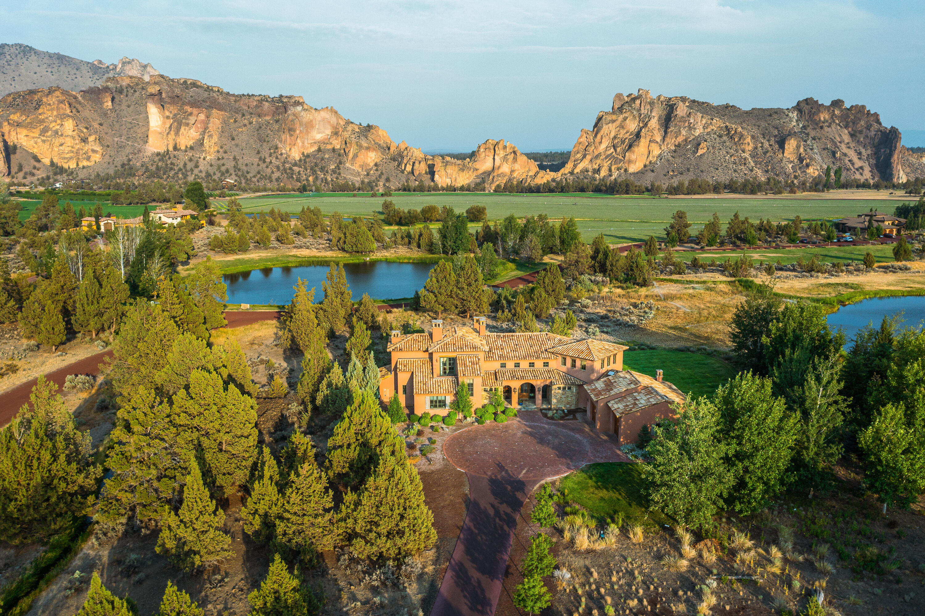 Experience the pinnacle of luxury at Ranch at The Canyons. Perfectly situated to capture breathtaking vistas of Smith Rock and 1,700 acres of pristine ranchland, this custom designed home is a masterpiece of craftsmanship. Rich hardwood floors, soaring exposed beams, and elegant stonework create an atmosphere of timeless sophistication. Three equally beautiful en-suites offer unparalleled comfort, while the chef's kitchen boasts a Sub-Zero refrigerator, Wolf range, farm sink, and wine fridge. Outdoor living is elevated with a vast wraparound covered porch, built-in BBQ, and fireplace, all overlooking panoramic views. Residents enjoy exclusive access to private ranch amenities including the Old Winery Clubhouse, fitness center, steam and sauna rooms, heated pool, pickleball courts, Tuscan stables, and 12 serene lakes. A truly exceptional offering.