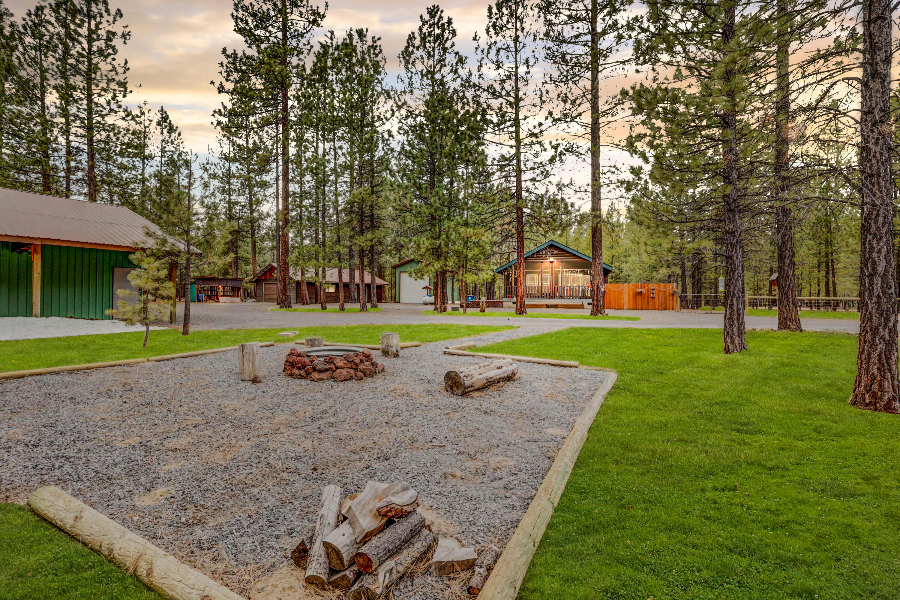 10.59 acres nestled in the pines! Looking for privacy and a place for all your toys? Here you go! This property features four outbuildings: A 30' x 36' shop with a loft, separate storage room, and lean-to's off each side. A 16' x 40' RV shop with 50 amp service and 12' roll up door. A detached 24' x 40' garage with a workshop, full bathroom, and an area for a woodstove to be placed! AND an additional wood shed. Storage won't be an issue!  The cozy log style manufactured home features 2 bedrooms, 2 bathrooms, a wood stove, open concept living, and a covered front deck! This property has everything you need to experience Central Oregon living to the fullest including direct access to public lands/trails and even a fire pit area to take advantage of the summer nights under the stars! Don't miss your opportunity on this move-in ready home!
