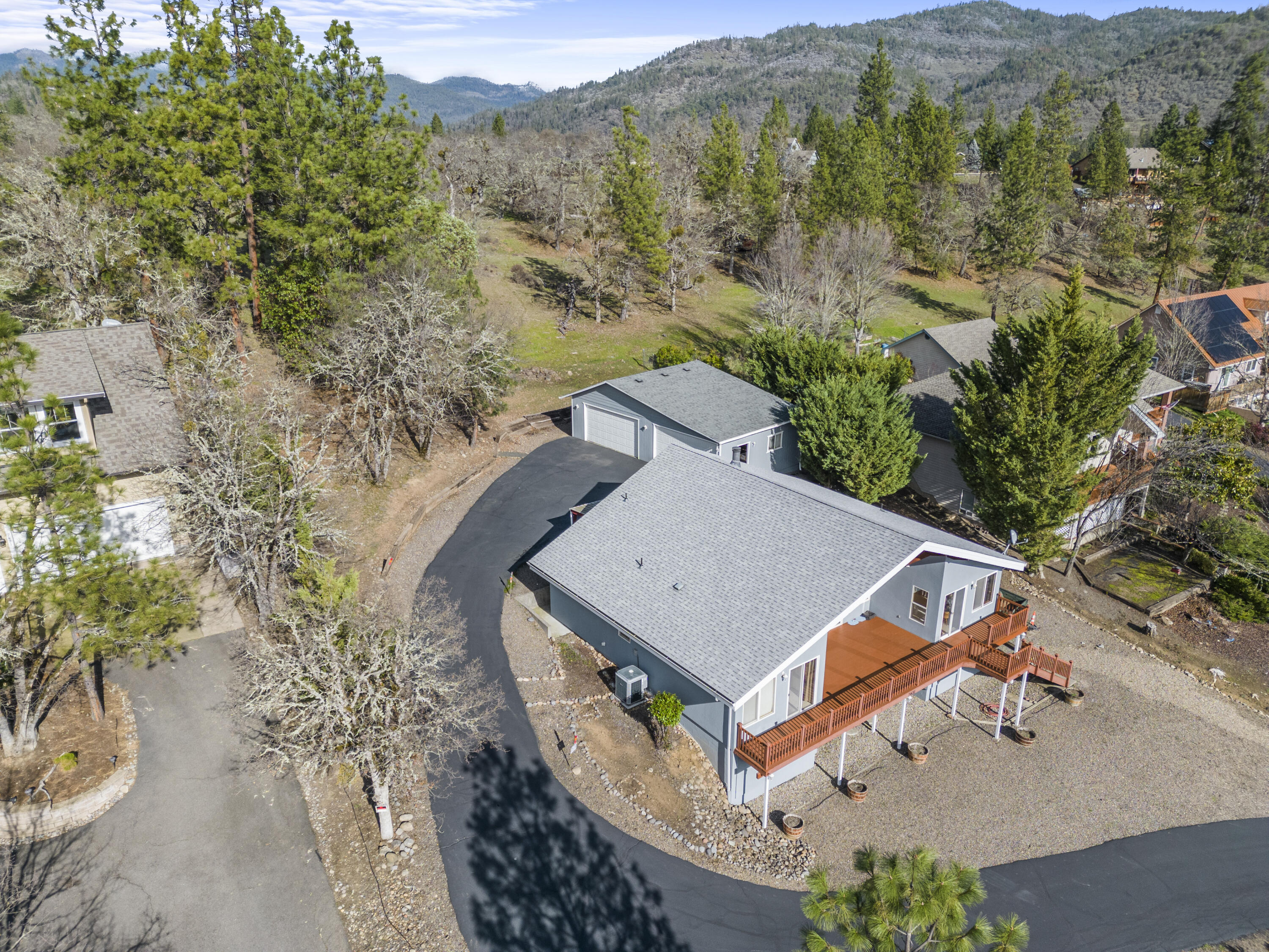 Wake up to some of the best views of the Rogue River! This idyllic retreat sits on half an acre with a fully paved driveway which was recently seal coated! The home encapsulates tons of natural light, featuring vaulted ceilings and huge open living room windows that frame the breathtaking scenery. With an open designed split-floor plan, this 3-bedroom, 2-bath haven also features a versatile loft, a large partially finished basement (1,000+SQFT) which would be perfect for an ADU or extra living space, and a detached 4-car shop/garage! Additional amenities include RV parking, a covered patio for entertainment, a centrally located breakfast bar, and a cozy wood-burning fireplace. This property is on city water & sewer. The Roof, HVAC, and Water heater are all in great shape!