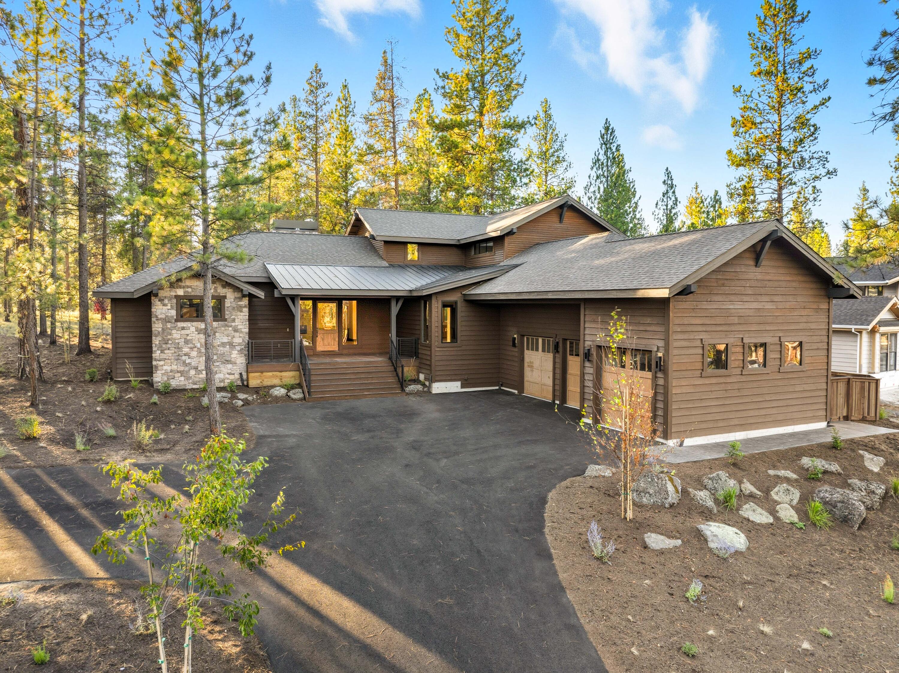 Situated in the private residential community of Caldera Springs, this 5-bedroom home offers luxurious spaces and NW contemporary styling. This 3,770 SF floorplan welcomes entertaining and gathering with spacious interiors, multiple ensuites and outdoor living on the elevated front porch & back patios. The home features hardwood flooring, custom built ins, tile surround fireplace, stained knotty alder cabinetry, a large quartz island and Jenn-Air stainless steel appliances. The main level offers two ensuites, including the spacious primary w/access to the back patio. Upstairs you'll find an additional ensuite, and two more bedrooms, ideal for bonus, bunkroom space or guestrooms. Insulated 3-car garage, electric car charging outlets and certified Earth Advantage. Caldera Springs owners enjoy an exclusive suite of luxurious and recreational amenities. Enjoy miles of trails alongside lakes & streams, outdoor pools, fitness centers, Forest House, Lake House, 9-hole golf and much more.