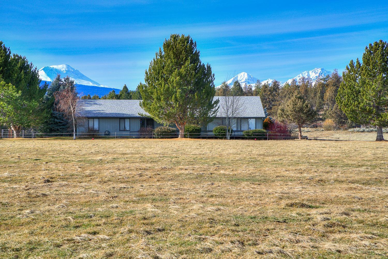 Premier Tumalo Location-as far west as you can go. Bring your horses & ride for miles at Tumalo Reservoir. Property has huge Cascade Mtn Views from irrigated acreage. Home looks out to Mtns & overlooks the pond. Espansive desk. Private well, natural spring runs through SW corner. 11 acres Adjudicated Tumalo water rights. Level orchard grass pasture w/wheel lines. Existing home is ready for your personal touch! Bonus room off garage has private entrance & 1/2 bath (potential ADU?) Don't miss this one!
