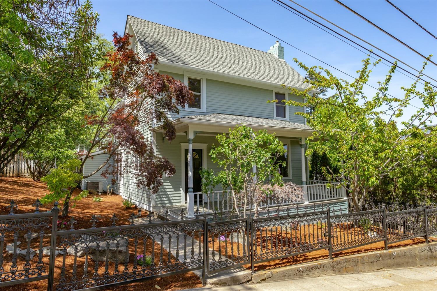 This rare vintage home, known as the Farlow House, sits just blocks to the plaza and Shakespeare! Originally built in 1865, and remodeled extensively in 1975, the home still welcomes one to the charm of the era with a full-width front porch, hipped roof & turned posts. Situated on a generous .30 acre lot with a gated entry, it features an in-ground pool among mature trees with plenty of room for outdoor entertaining. The main home has been recently painted inside & out and features a classic entry way boasting crown moulding, beveled glass and high ceilings, a formal living room with fireplace, a formal dining room, a sun room and a sweet library or reading nook. The kitchen opens out to the rear patio, has views of Grizzly, a breakfast area and an adjacent laundry room. Upstairs you'll find all three bedrooms and a full bathroom with double sinks. The apartment/guest quarters is above the garage. Don't miss this opportunity to own one of Ashland's originals!