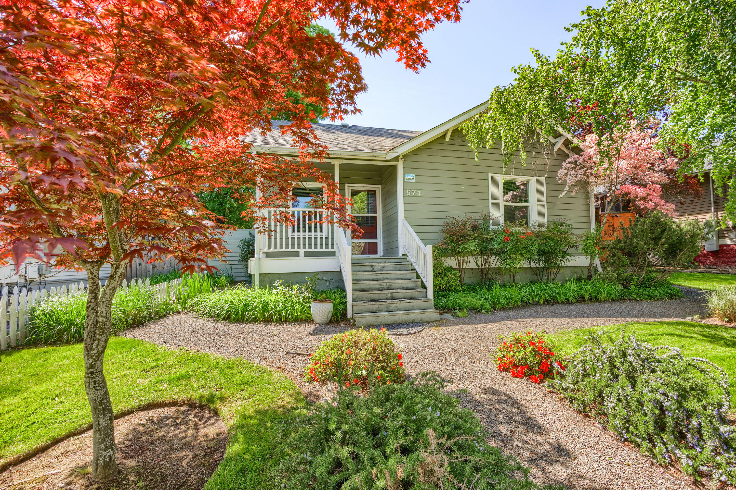 This property is ideally located in a prime commercial district, just a few blocks from Ashland Public Library and within close proximity to major city attractions. The main house is a charming 2-bedroom, 1-bath Craftsman-style home featuring a fireplace insert and fir floors. The triplex includes Unit #2 and Unit #3, both offering loft-style bedrooms with 20-ft cedar-lined ceilings and skylights that brighten the living spaces below. Each unit also has a small office/bedroom on the main floor, a full kitchen, and a bathroom with a shower/tub. Unit #4 is a single-level unit with a vaulted cedar ceiling and skylight, allowing ample natural light. The house, Unit #2, and Unit #4 all come with a washer/dryer. The owner could live in the main house while renting out the triplex for additional income.