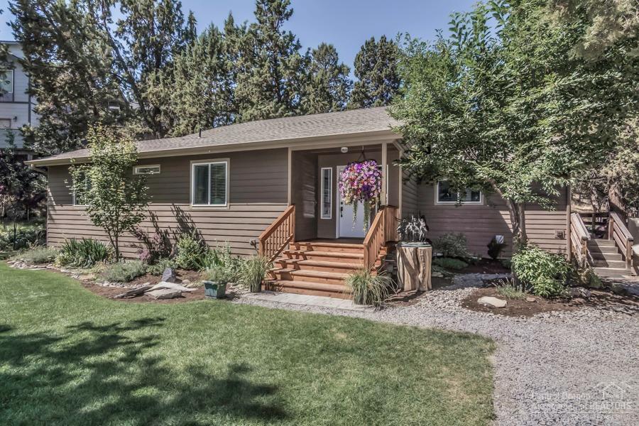 Welcome to Tumalo! This charming home boasts many modern updates & is nestled nicely on a .27 acre lot close to the Deschutes River. This single level 3 bedroom, 2 full bath home has nice separation, updated kitchen, hardwood floors and detached 2 car garage. Great outdoor space w/ spacious front yard, private back deck, beautiful natural rock outcropping's, colorful landscaping, irrigation & a fenced perimeter.Don't miss the fire pit complete w/grass surround & natural rock seating.Tumalo Schl. District!