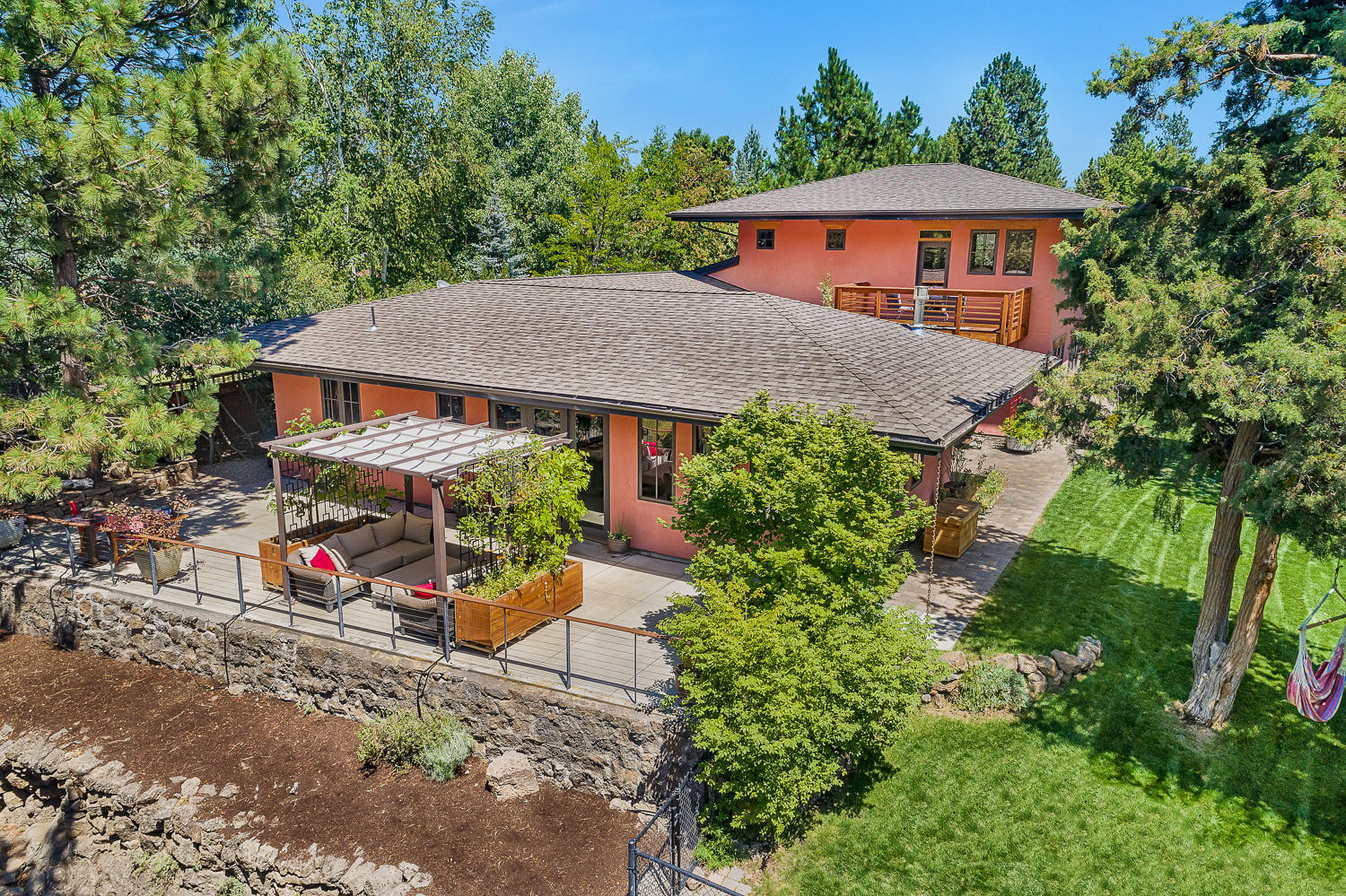 Exceptional opportunity to live in a thoughtfully designed custom home on the Deschutes River. Across from upper Sawyer Park & the Deschutes River Trail this riverfront location provides the coveted sanctity of a private setting along the river with stunning scenery, abundant wildlife & tranquility. Guests are greeted by a private paver courtyard leading to the entry & great room overlooking the river. Custom aluminum clad wood casement windows adorn the home offering abundant natural light coupled with 5' eaves to protect from afternoon sun. Downstairs features a great room floor plan with radiant concrete floors, expansive kitchen, Carrara marble counters & generous island. Two guest bedrooms with private full bathroom, half bathroom, laundry room & a multi-purpose room featuring roll up door complete the first story. Upstairs features the resident's suite with dual closets, private bathroom, extra space for home office or gym along with a balcony overlooking the patio & river canyon