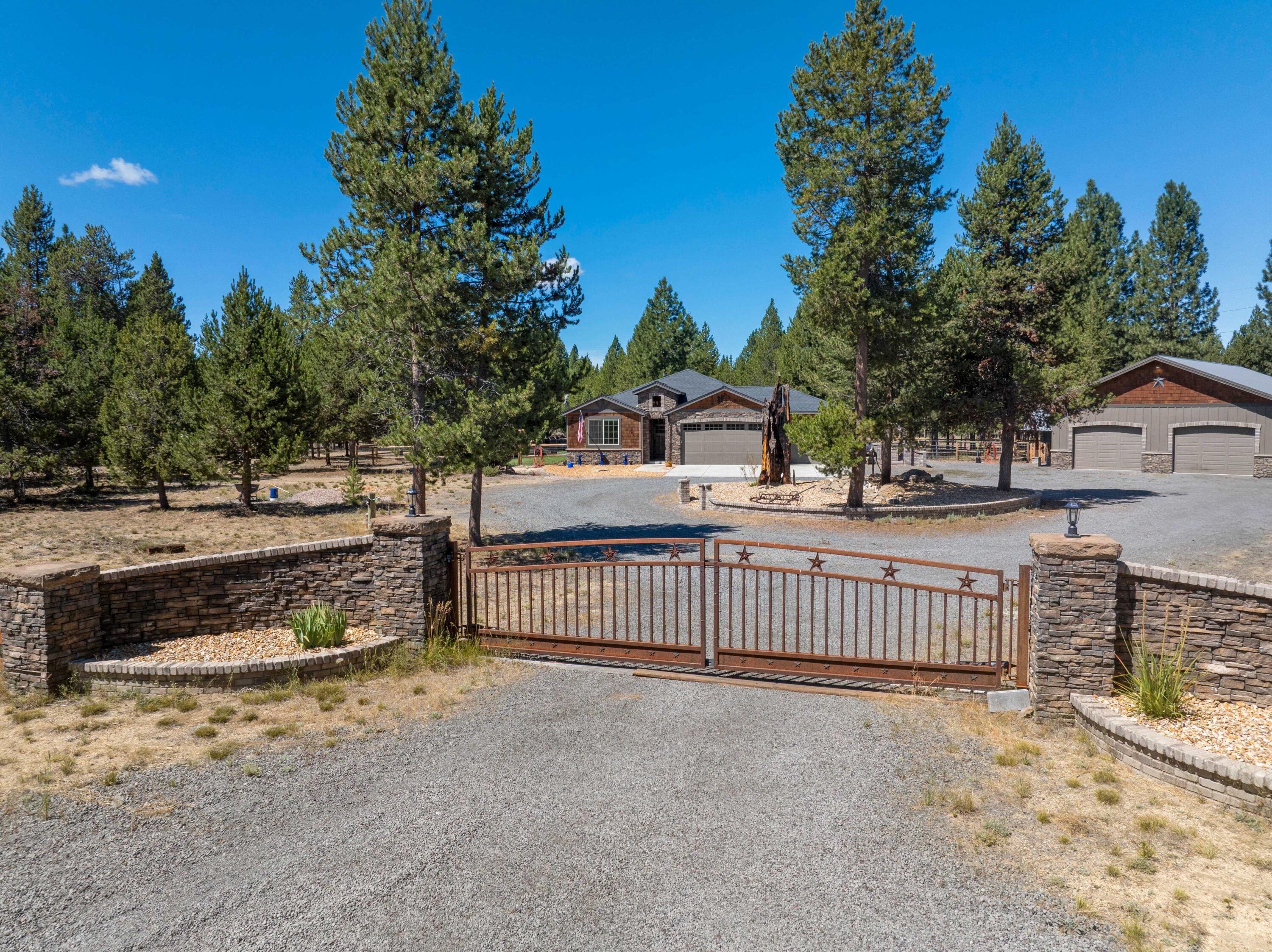 A blend of horses, comfort & outdoor entertaining! Discover your private 5-acre retreat just minutes from La Pine. Set behind a gated entry with a circle drive, this property blends modern comfort with true Central Oregon charm. Enjoy a horse-ready setup with a roping arena (230x140) with chute/return, round pen, 3 stalls, fenced and cross-fenced pastures, plus an irrigation well with cistern for easy arena watering. The spacious 48x60 shop includes a full mother-in-law suite with its own bathroom, kitchenette, laundry, and heating. Inside the custom home, you'll love the open layout, updated kitchen boasting quartz counters, and two primary suites. Outside, relax in the hot tub or entertain on the covered patio and cantina area that can be left open in the summer or closed off for the chilly winter nights. With two 50 amp RV hookups, ample parking, and room for all your animals and toys, this property is ready for year-round living. Ask your agent for a full list of amenities!
