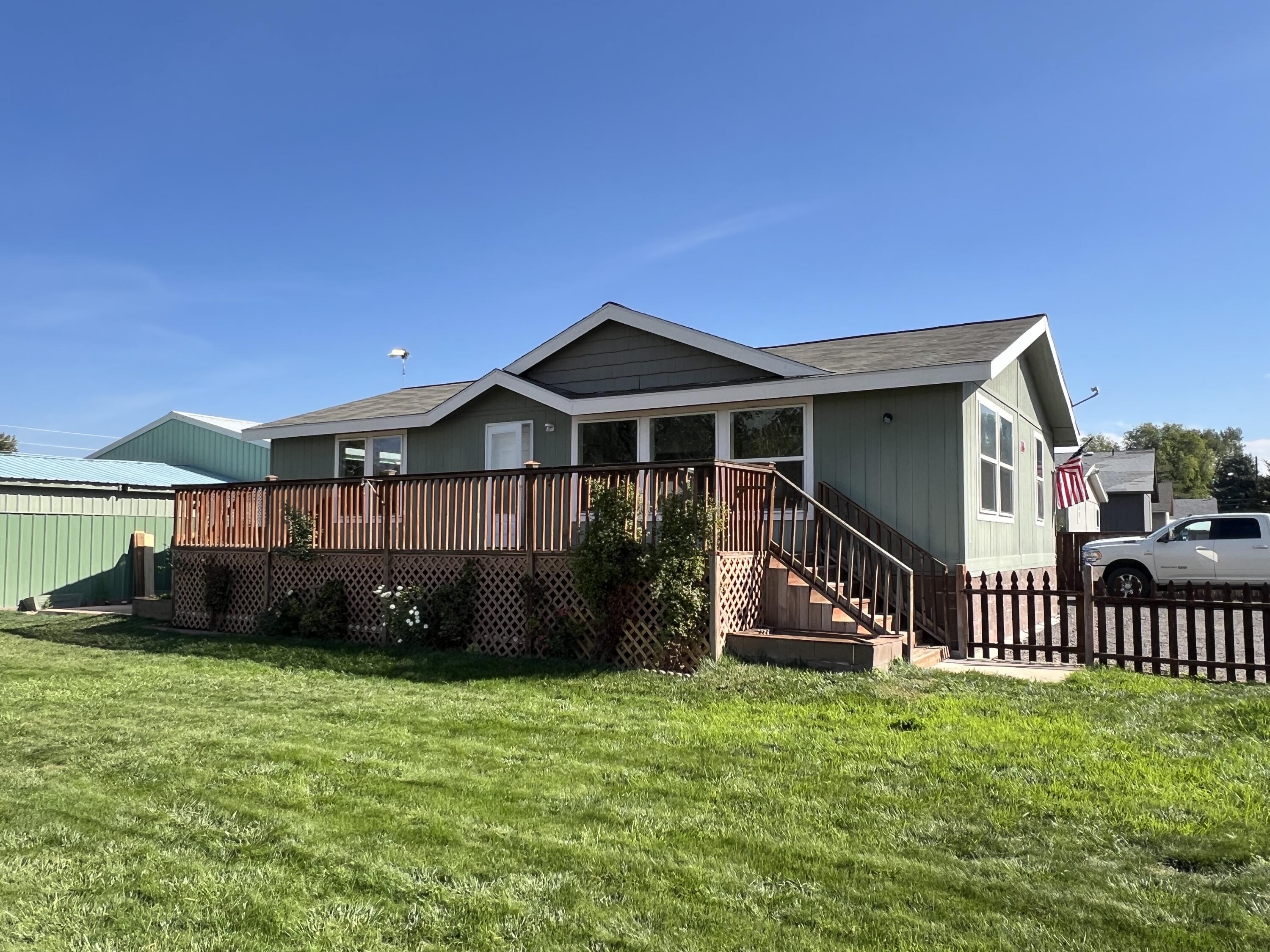 Home in town with a large shop! This 1,188 sf, 2 bedroom, 2 bath home on a .26 acre lot in town offers an open concept living area, tons of natural light, and a split bedroom floor plan. Enjoy the convenience of in town living with 1,080 sf insulated shop with attached carport; in addition to a large fenced yard with plenty of space for gardening, pets or outdoor entertaining.