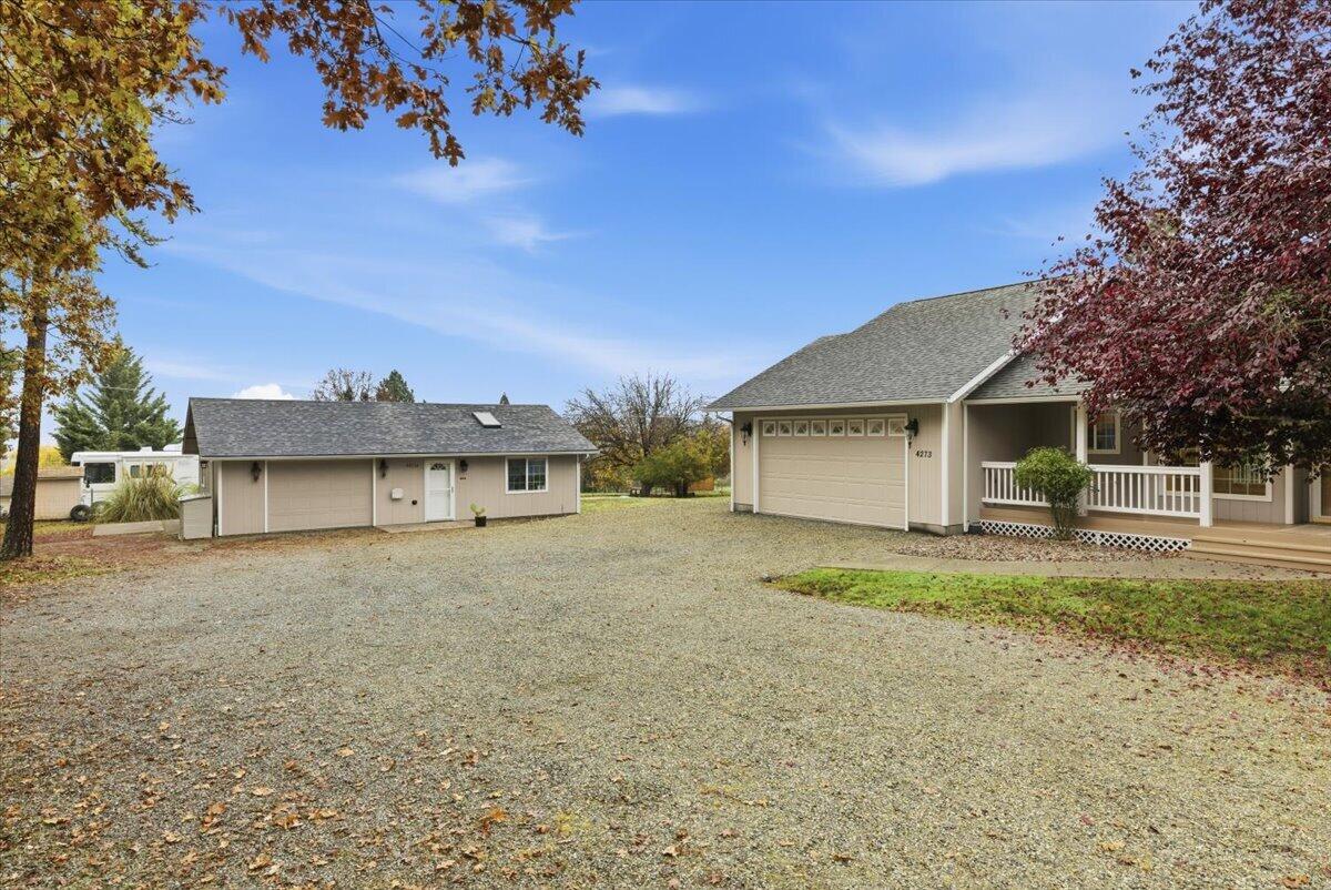 Open House Sunday (11/16) from 11:00-1:00. Desirable Jerome Prairie area single-level 3 bed / 2 bath main home on a level 1-acre lot with a permitted ADU and two garages. You'll love the tree-lined drive, covered front and back porches, and open great room with vaulted ceilings, skylights, LVP flooring, and large windows that frame the park-like setting. The split-bedroom floor plan places the spacious primary suite—with double closets and ensuite bath—on one side of the home, with two additional bright bedrooms on the other for added privacy. The kitchen offers oak cabinetry, generous counter space, and a sink overlooking the yard. Outside features an oversized attached 2-car garage with workbench, plus a second garage at the ADU, abundant level parking, and room for RVs, toys, and a garden—all just minutes from town with a peaceful rural feel. Property offers a strong cash-flow opportunity:  ADU is currently rented for $1,375/mo, and the main home previously rented for $2,065/mo