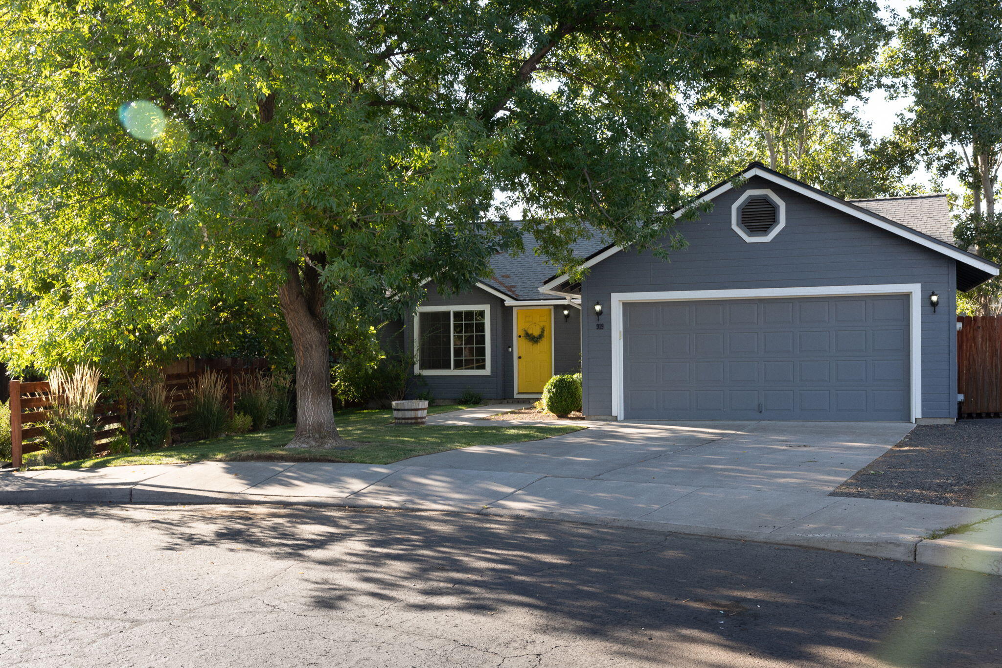 Tucked at the end of a quiet cul-de-sac, this charming 3-bedroom, 2-bath home is move-in ready and beautifully maintained inside and out. Inside you'll find a welcoming main living area with vaulted ceilings, rich laminate floors, and a stunning wood-burning fireplace insert surrounded by stone. The kitchen shines with stainless steel appliances, granite countertops, and a gas range, perfect for everyday living and entertaining. A newer roof provides peace of mind, while the south-facing covered deck offers a sunny spot to relax year-round. Outside, the large fully fenced backyard is a true retreat with mature trees, lush lawns, a sprinkler system, raised flower beds with irrigation, and even space to park your RV or boat. A woodshed adds extra convenience. This home is located near the West Canyon Rim City Park and the Dry Canyon Club, a great place to relax, explore trails, and meet up with friends. Possibility of loan being assumable.