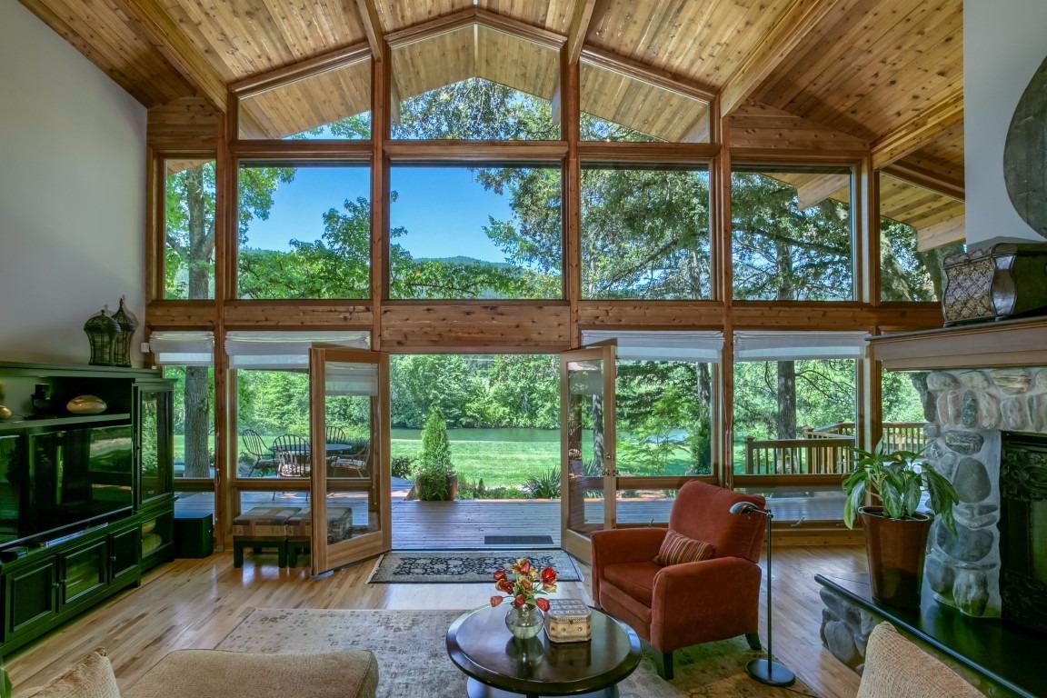 Applegate River frontage property! Come home to the True Oregon Riverfront Dream. This is a gorgeous Lindal Cedar Post and Beam home built in 1999, with a very open and light floorplan with 22 foot ceilings and walls of windows. The large 1200 sq ft deck off of the kitchen and living room is open to the river views and it perfect for entertaining family and friends. The spacious master suite is beautiful with an extra deep soaking tub, travertine floors, and marble inlay in the shower. The gourmet kitchen has a large island GE Monogram refrigerator, Jenn-Air double ovens and Jenn-Air gas range (replaced in 2016). There are wood floors throughout, four large bedrooms, two and a half baths, 3668 sq ft, and on 3.15 fully irrigated acres. There is a great barn for the horse lover, or hobby farmer, and the front pasture is fully cross-fenced. This home has captured magnificent views from almost every window. Conveniently located 13 minutes to Jacksonville and 25 minutes to Medford.