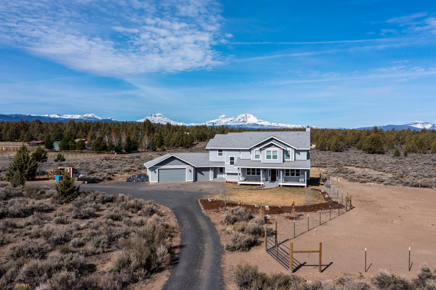 This beautiful custom-built home with amazing mountain views sits on almost 10 acres that backs up to public land, providing privacy and tranquility. Solid wood flooring and granite counters in chef's kitchen are just a few of the finishes that accentuate this fine home. Large Primary bedroom has private balcony that faces the mountains, perfect for enjoying a morning cup of coffee or spectacular evening sunset. 4 bedrooms and three full bathrooms plus bonus room provide space for home office or workout room.  The covered patios are great outdoor living space that can be enjoyed in all types of weather. The property sports a 900 sq ft shop and 3 car garage providing plenty of space for all of your toys. To many things to list on this great property, come see all it has to offer.