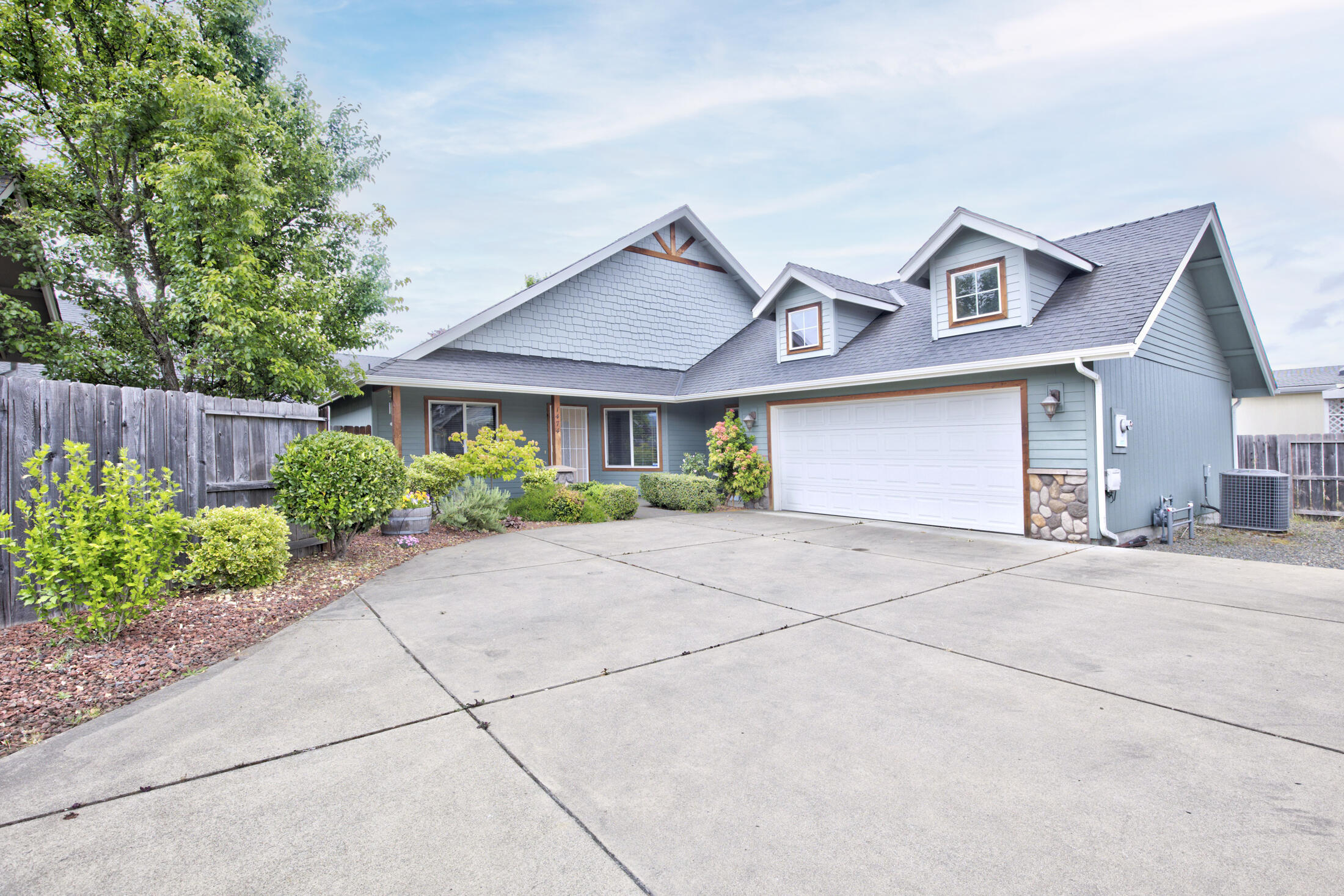 Beautiful, single level, 4-bedroom, 2 bath home, tucked away in a quiet Grants Pass neighborhood. Cute covered front porch invites you into a large living room and well-appointed kitchen with granite counters and stainless appliances. Kitchen includes nice sized dining area with views of the back yard. Large master suite offers access to a covered patio and the master bathroom is complete with double vanity and huge walk-in closet. Home offers 3 guest bedrooms, guest bathroom and a laundry room which leads into the, 2 car attached finished garage with storage area above. Easy to take care of, fenced back yard with patio.  Recent $8,000 in new flooring.