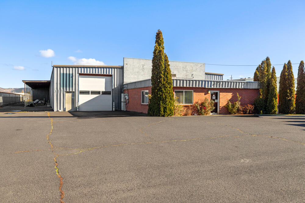 Industrial building on 2.13 acres across from Super Wal-Mart on busy Washburn Way corridor. Located in an area of expansion. Includes approx 3000 sq. ft. of office space, kitchen, walk-in refrigeration, large warehouse with loading dock and four roll-up doors and 2.5 bathrooms. 3-phase electric.