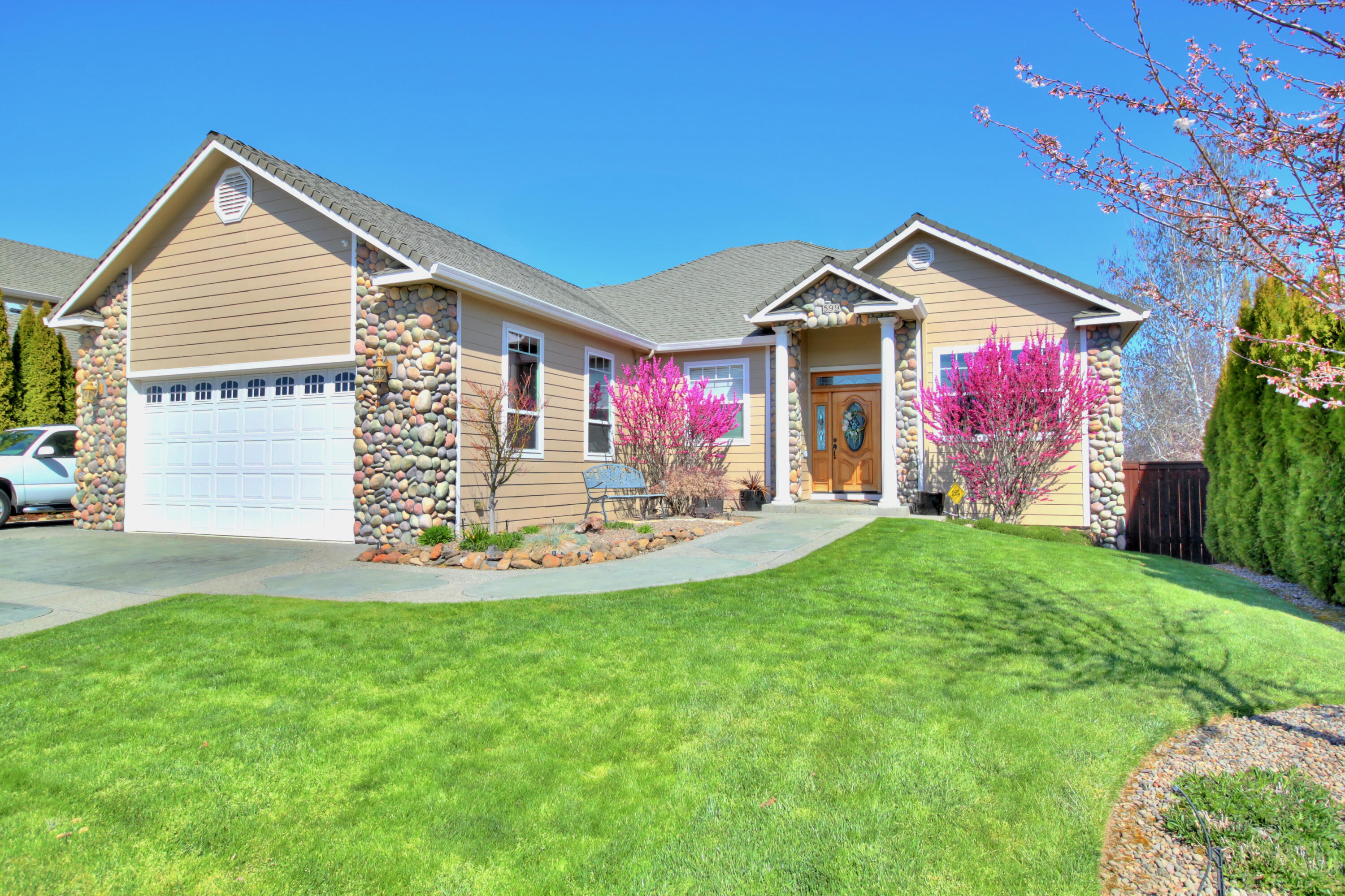 A stone's throw from the 17th green and cart path of the Eagle Point Golf Course, this custom home is sure to please the most discerning buyer with main level living and sweeping valley views. The open floor plan offers a formal dining room with tray ceiling and wainscoting, an office, spacious kitchen with pantry and breakfast bar, dining nook, and opens to the family room with access to the expansive covered balcony with gas hookup for your grill. The large main floor primary suite has a walk-in closet, double vanity, step in shower, jetted tub, and water closet. There is also a full guest bath on the main level with tub/shower and pedestal sink near the laundry room on the way to the oversized 2-car garage. The daylight basement features 4 bedrooms, one with ensuite, a full guest bathroom, huge storage area in the unfinished basement, and bonus room with wet bar and counter seating, which opens to the covered patio and nicely landscaped back yard. Schedule your tour today!
