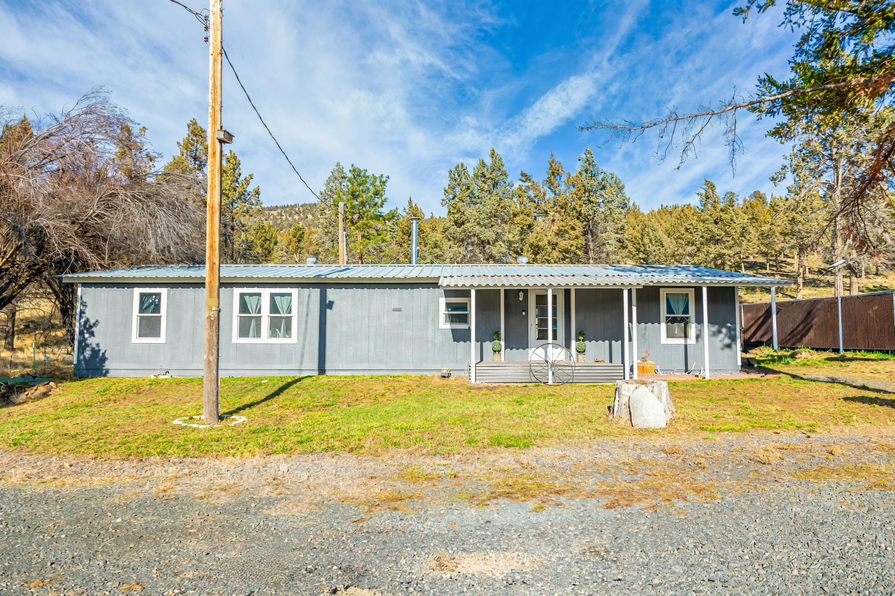 Beautiful 9.85-acre fully fenced property just minutes from town. This turn-key country retreat features a newly renovated manufactured home with fresh updates throughout. A private gated entrance leads to open, usable acreage with multiple outbuildings offering excellent storage, workshop, or hobby space and is also backed by over 2,300 acres of BLM land for additional privacy.

Property includes a private well and septic system, providing added independence and lower utility costs. The land is ideal for livestock, gardening, and many more hobbies and lifestyles. Enjoy peaceful rural living with easy access to town amenities. Move-in ready and full of potential—this one is a must-see.