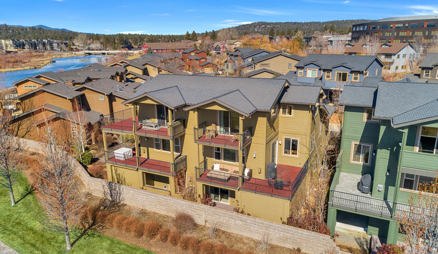 Nestled in the heart of the Old Mill District! Enjoy the Deschutes River trail, restaurants, shopping, concerts, and nature right out of your front door in this Otter Run townhome. Soak in the Bend lifestyle on large deck with mountain, peek-a-boo river, and old mill views. Well-appointed with Acacia wood floors, stone gas fireplace, wood wrapped windows, and elevator to each level. Kitchen has slab granite countertops, and stainless-steel appliances. Large 2 car garage has an additional, enclosed storage room for all your outdoor activity gear. Welcoming entry on the 1st level with large space to remove coats and shoes, leads to a junior suite, laundry room, and doors to the back patio. You will find the large great room, with beautiful kitchen, warm living room, large bedroom and full bathroom on the 2nd floor. The top floor holds a large primary suite with walk in closet, gorgeous bathroom, and private deck to enjoy the views. Convenient location while living the Bend lifestyle.