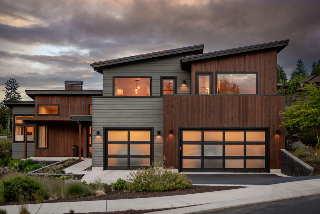 Clean lines and a fantastic floor plan! This stunning Tetherow home is situated on a corner lot and backs to Alpine Park for privacy and natural vegetation.  Cascade mountain and golf course views!
High ceilings and generous use of glass and windows for light.  Architectural detailing creates volume and incredible spaces with beautiful design touches.
Open, great room floor plan with large kitchen.
Primary on the main level and three en suites upstairs and a great Bonus room.
Wonderful incorporation of outdoor living spaces!  One upstairs deck off of the Bonus room with gas firepit overlooking the mountains and golf course, the other off the great room with fenced privacy, another gas firepit and hot tub.
Highly sought after Tetherow community with world class golf, fitness and incredible member facilities.