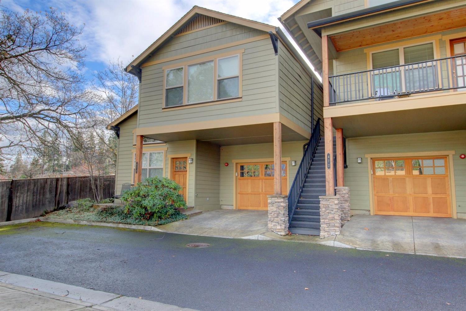 Fantastic 2005 built home in the heart of Ashland and close to Southern Oregon University! This end unit Beach Street condo offers 1630 sqft, 2 bedrooms, 2 baths, and lots of privacy. Great for entertaining with a large open kitchen finished w/ granite counters, peninsula bar seating, & beautiful cherry cabinets. Kitchen opens to the inviting living room offering hard wood floors, a cozy Franklin stove, ceiling fan & high beam / vaulted ceilings with lots of windows and tons of natural light. Upstairs boasts a large guest bedroom, guest bathroom, desk sitting area & large master suite with vaulted ceilings & great views, walk in closet, dual vanity, & fabulous walk-in travertine tile shower. Huge laundry room on the main level along with half bath, fully finished deep single car garage w/ storage & small front porch. Peaceful common area outside the front door with sitting area & ample guest parking. Close to parks, downtown shopping & transportation! Comes Furnished.
