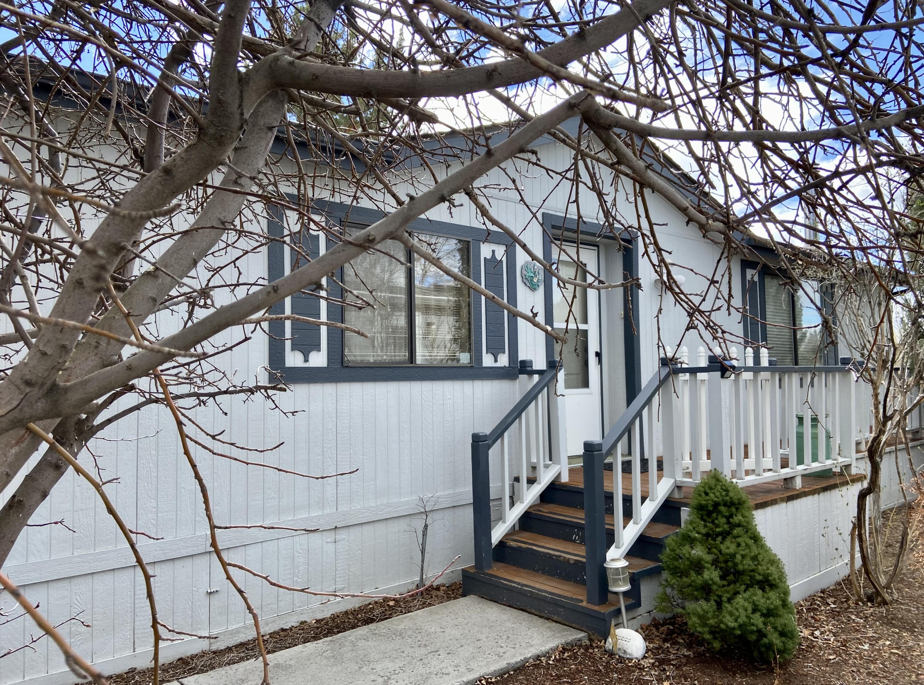 Located in the 55+ manufactured home community of Cascade Village in NE Bend.  Open floor plan with laminate flooring throughout main living areas and bedrooms.  Wood stove and central A/C help keep you comfortable year round.  Newer kitchen cabinets and quartz countertops.  Views of the mountains from the deck that overlooks the green belt.  Oversized 2-car garage.  Owner occupied only.  Space rent  includes clubhouse, pool, street snow removal and sewer.  Sale is for manufactured home only, land not included.  Park management must approve buyer.