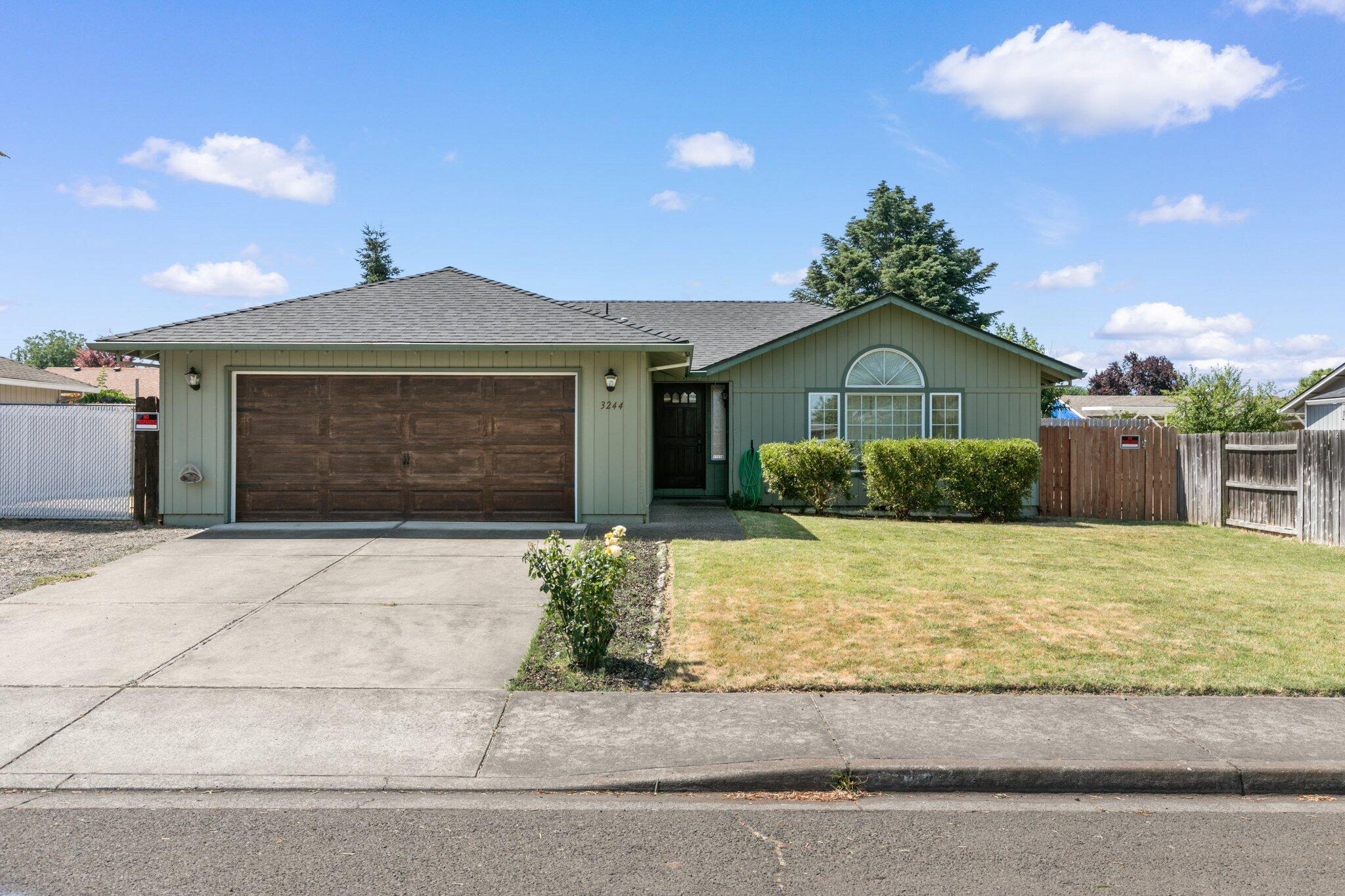 Unleash the Potential of this East Medford Gem! This 3-bed, 2-bath home boasts a great layout and endless opportunities for customization. The spacious living room, adorned with vaulted ceilings, invites you to create a cozy haven. The functional kitchen awaits modern upgrades, becoming the heart of the home. Step outside to the covered back patio, perfect for entertaining guests and with the newer oversized fence adds a special feeling of privacy. Ready to take the toy hauler out his weekend? Look no further, with this spacious RV parking, you won't have to make the extra stop to pick up the trailer. Conveniently located near dining and shopping options, this property is your canvas for a dream home. Don't miss this incredible opportunity! Schedule a showing today.